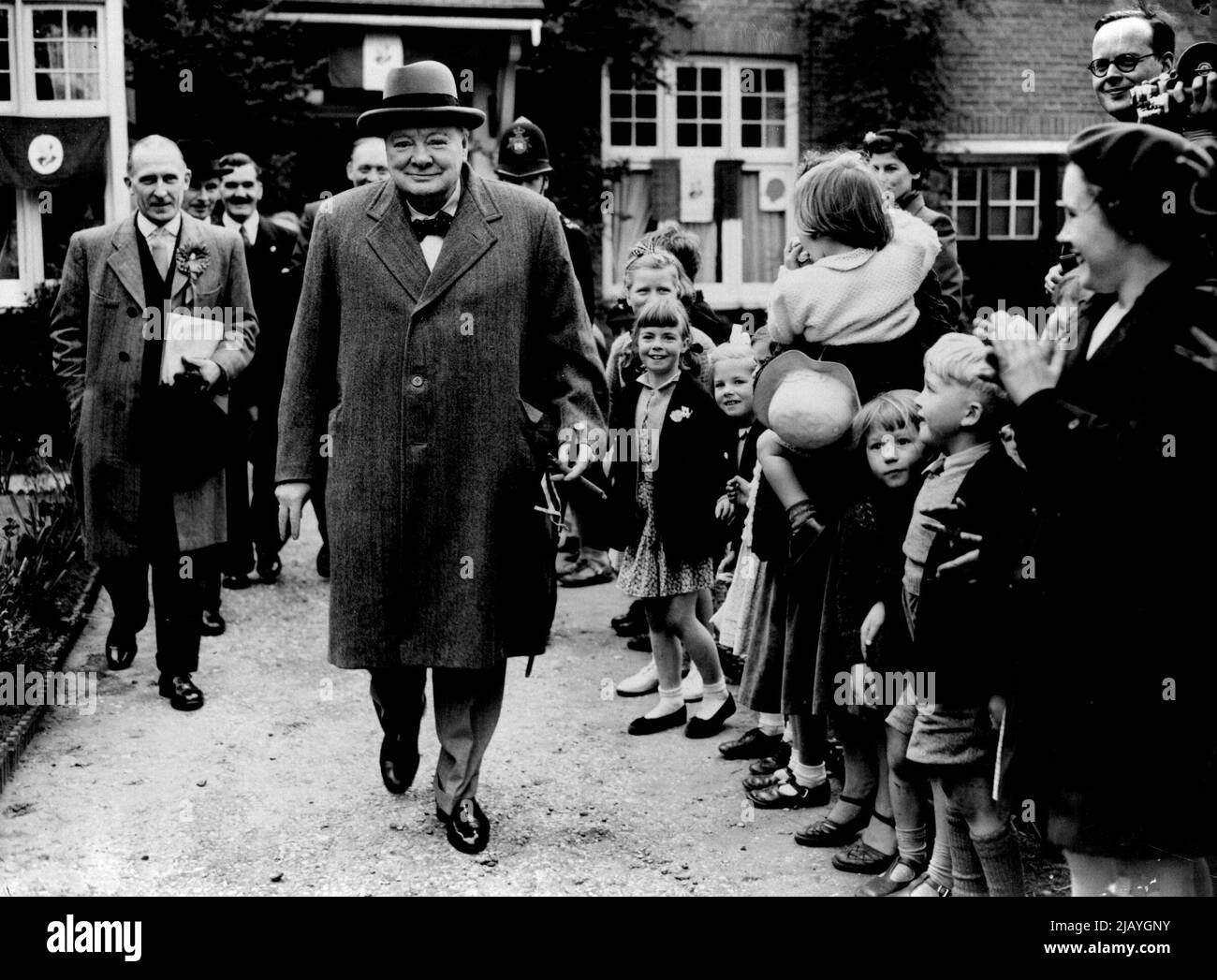 Churchill With Their Approval -- A beaming Sir Winston Churchill, looking in the best of health, gets applause and approving smiles as he leaves the Conservative Committee rooms at ' The Drive ' Wanstead, Essex, in an eve-of-the-poll Tour of his constituency to-day (Wednesday). May 25, 1955. (Photo by Reuterphoto). Stock Photo