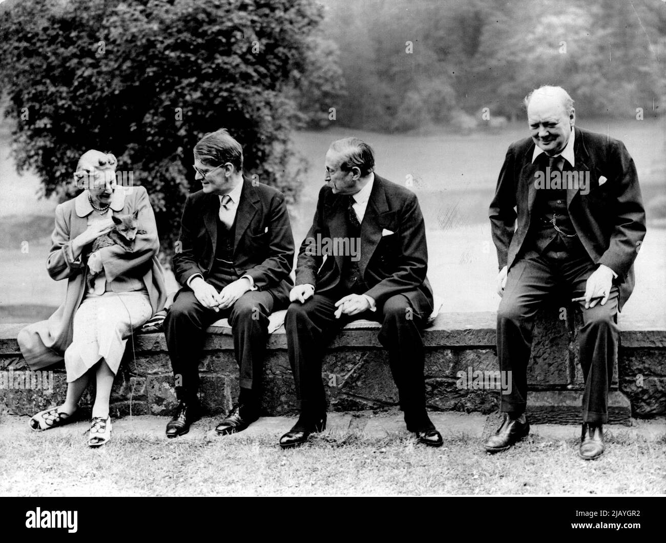 M. Leon Blum Visits Mr. Churchill At Kent Home - Left to Right - Mrs. Churchill (with a fox cub bred on the estate); Mr. Richard Law (son of the former Premier, Bonar Law); M. Blum and Mr. Winston Churchill at Westerham, Kent. M. Leon Blum, the French Socialist leader and former, who is visiting London to confer with prominent people on the question of conscription, visited Mr. Winston Churchill, the politician, at his country home at Westerham, Kent. May 10, 1939. Stock Photo