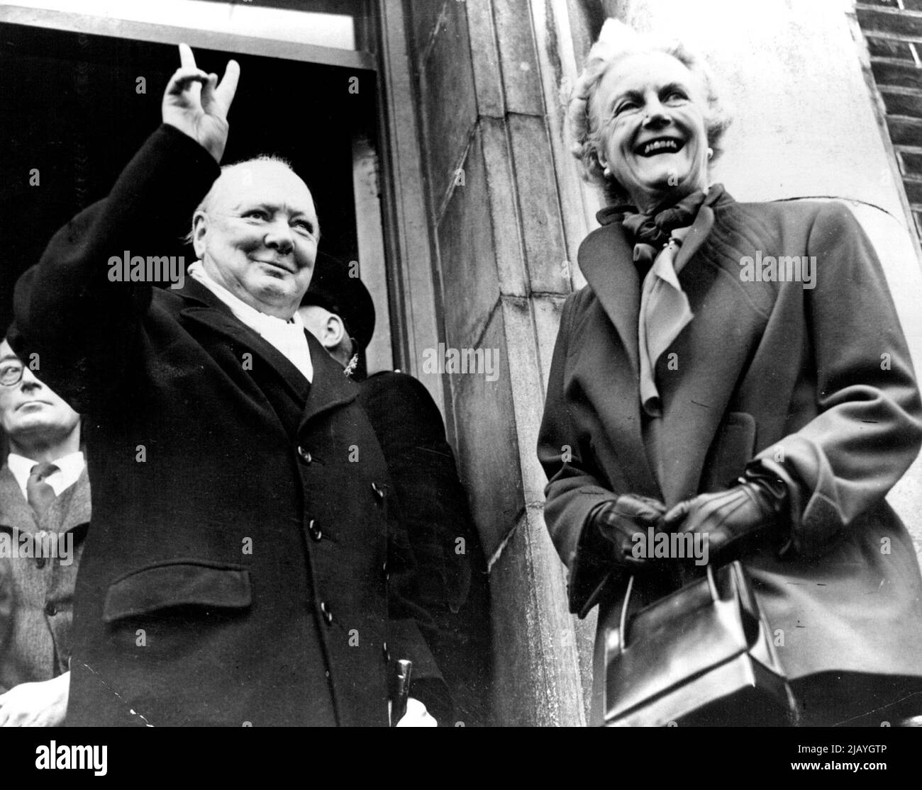 Churchill's Mission - Victory Salute popularized by Churchill during the war was the doughty Englishman's reaction to his latest triumph at the polls. His wife shares his newest moment of glory. December 23, 1951. (Photo by International News Photos). Stock Photo