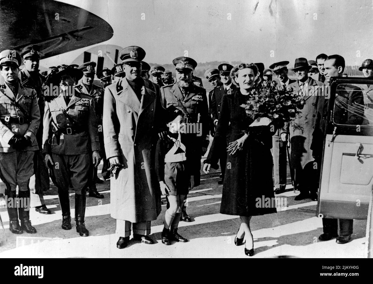 Count Ciano Returns From Vienna: Count Ciano, Italian Foreign ministers, photographed with his wife and son on arrival at the ***** airport Rome. On his return from Vienna, where he helped to draw up the frontier agreement between Czechoslovakia and Hungary. November 7, 1938. (Photo by Keystone). Stock Photo