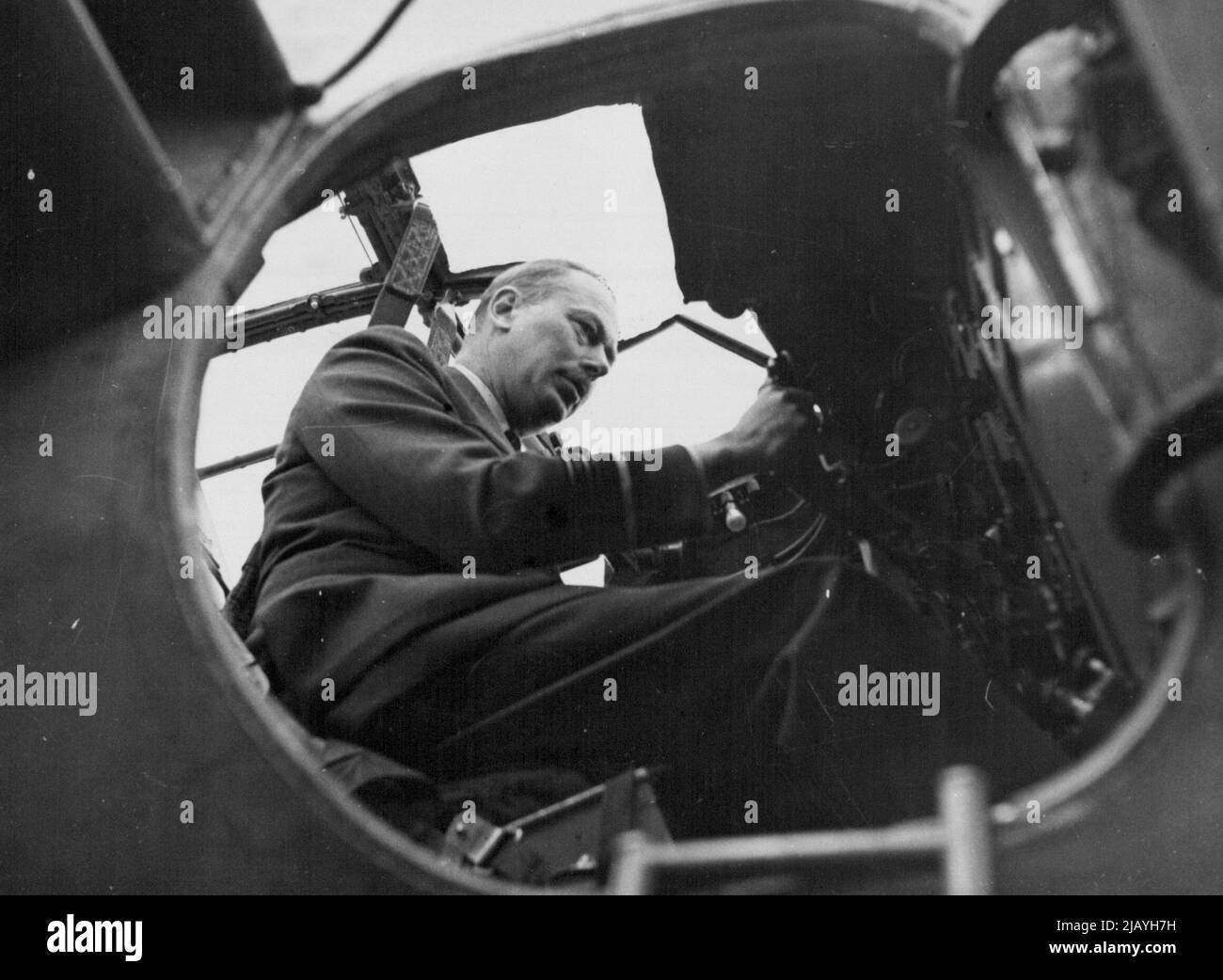 The Duke of Gloucester visits R.A.F. Station in South Wales -- The Duke of Gloucester at he controls of a Mosquito during his visit to an R.A.G. Fighter Station. Air Marshal H.R.H. The Duke of Gloucester visited R.A.F. Stations in South Wales, recently. He travelled by air and was accompanied by group captain Lord Willoughby De Broke, M.C. A.F.C., Deputy director of public relations, Air Ministry. August 30, 1943. (Photo by L.N.A.). Stock Photo