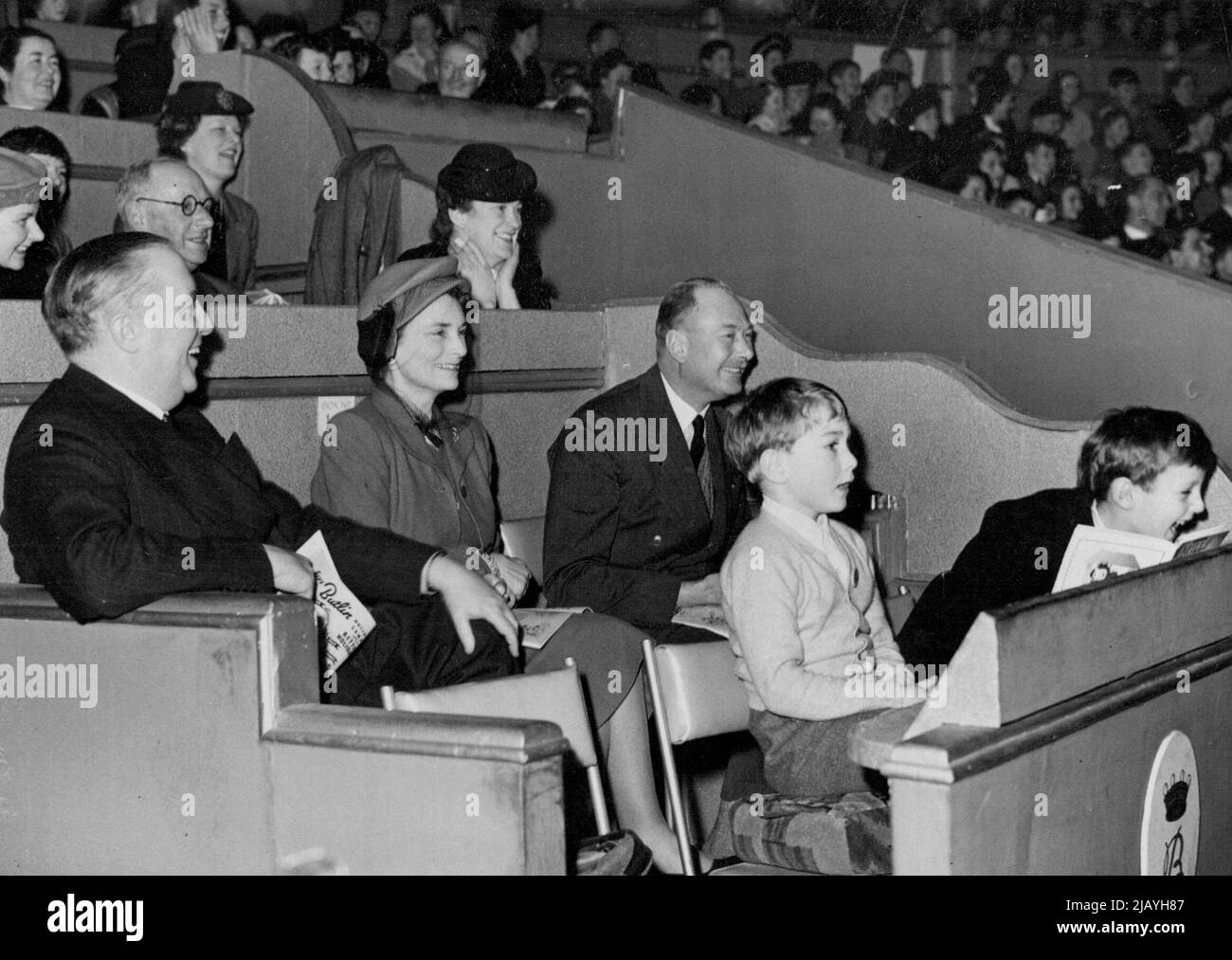 Duke Of Gloucester At Olympia -- The Duke and Duchess of Gloucester with Prince William on left, and Col. Howard Kerr, Aide de camp to the Duke, watching the performance, also seen on right is Col. Howard Kerr's son. H.R.H. The Duke of Gloucester, accompanied by the Duchess and their son Prince William visited Olympia today (Wednesday) to see Bertam Mills Cirous. January 14, 1948. (Photo by London News Agency Photo Ltd.). Stock Photo