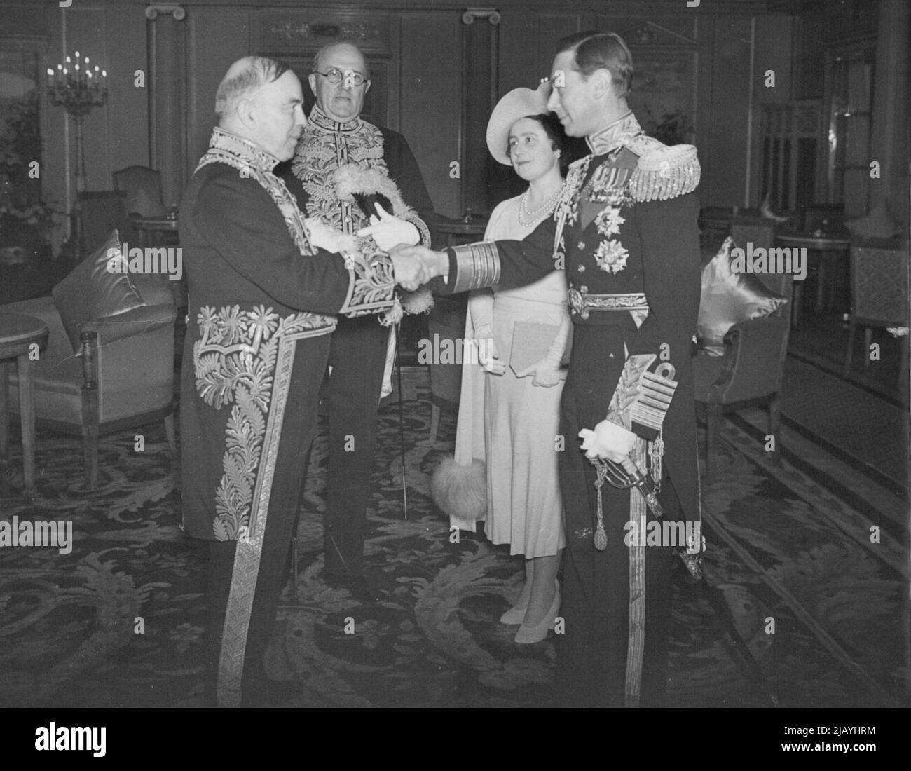 Royal Canadian Tour: Scenes On -- Board the Empress of Australia. Our photograph shows the King being greeted by Mr. MacKenzie King on board the Empress of Australia on Their Majesties arrival in Canada. June 13, 1939. Stock Photo
