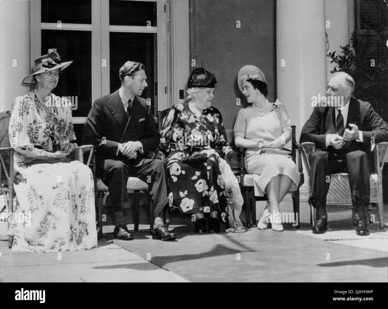 Royal Conversation Piece -- Left to Right: Mrs. Franklin D. Roosevelt, wife of the President; the King, the President's Mother, Mrs. Sarah Delano Roosevelt; the Queen, and the President. Four Members of the first families of Great Britain and the United States were caught by the camera in Antimated conversation when King George and Queen Elizabeth sat with the Roosevelts on the front porch of the Roosevelt family home at Hyde Park, N.Y., June 11. November 6, 1939. (Photo by Associated Press Photo). Stock Photo
