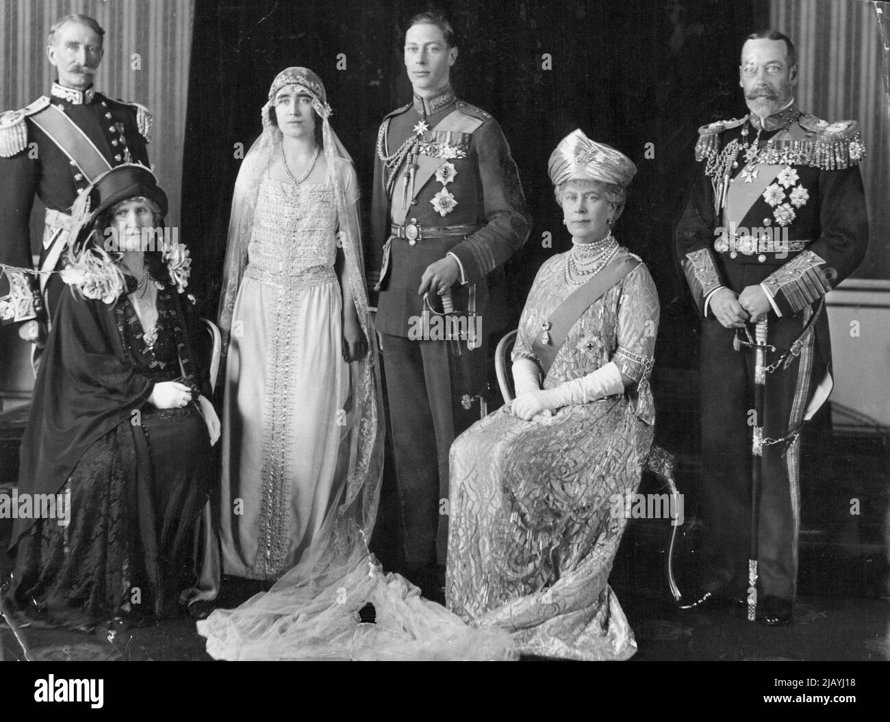 The Queen Mother, formerly Lady Elizabeth Bowes-Lyon, and the Duke of York - the future King George VI - at their wedding in 1923, seated is Queen Mary with King George V. January 04, 1937. Stock Photo