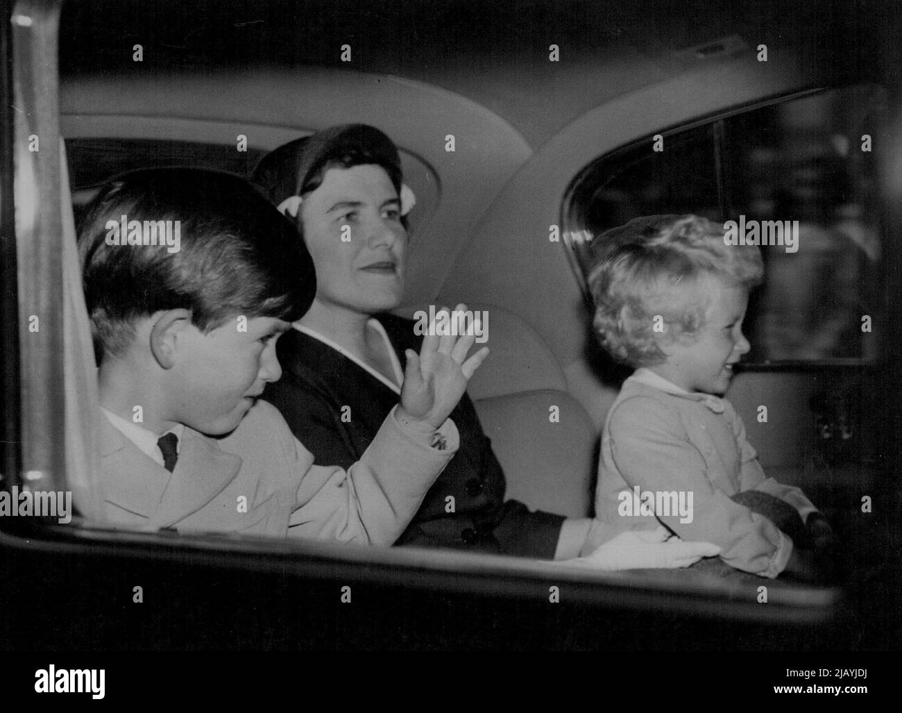 Royal Children Return To London -- Prince Charles and Princess Anne, sitting with Nurse Lightbody, drive from Euston Station to Buckingham Palace following their return to London this morning from Balmoral where they have been spending a holiday with the Queen and the Duke of Edinburgh. The Queen returned to London yesterday. June 01, 1954. Stock Photo