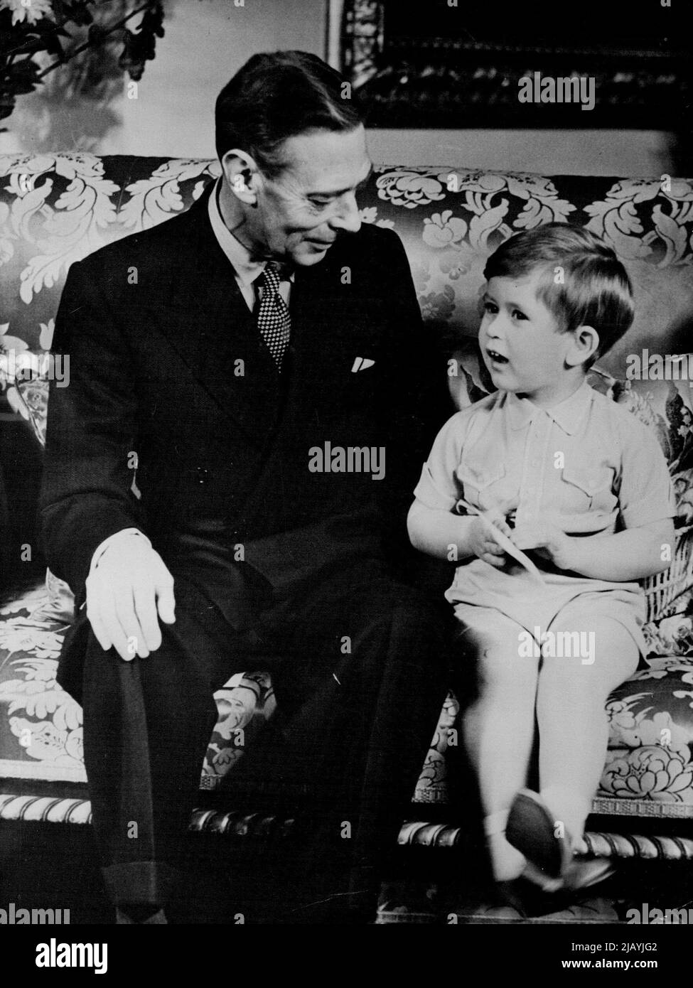 First Picture Of The King As He Celebrates Prince Charles Third Birthday -- The King with his grandson Prince Charles, at Buckingham Palace, London, today November 14. The Prince Celebrated his third Birthday anniversary today with a tea-party at the Palace. This is the first picture of the king since his recent serious unless. July 19, 1953. (Photo by Associated Press Photo). Stock Photo