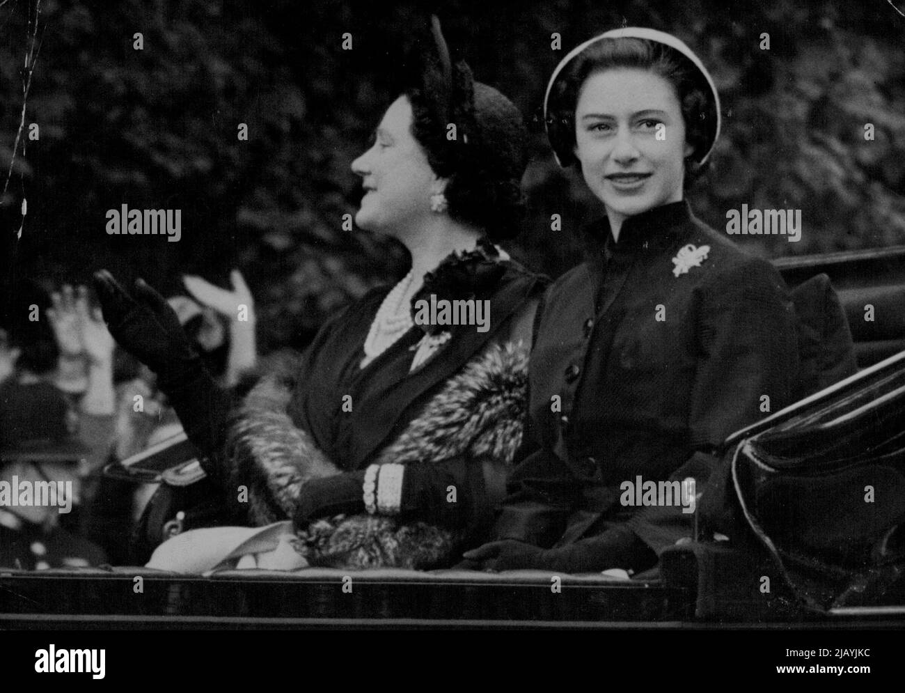 Queen Mother Drives to Trooping of Color: The Queen Mother (left) and Princess Margaret drive in an open carriage to Horse guards parade, London, this morning June 05, to attend the trooping of the colour in honour of Queen Elizabeth's II's 26th official Birthday. The Queen took the salute from her Majesty's Horse 'Winston.' Round: Princess Margaret complained recently that her face had grown too fat. June 05, 1952. (Photo by Associated Press Photo). Stock Photo