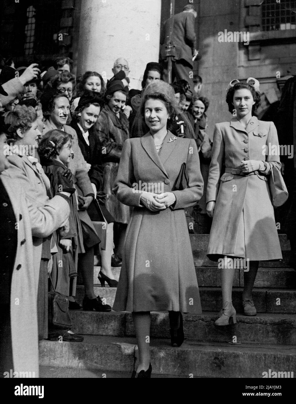 Married At St. Martin's -- Princess Elizabeth and Princess Margaret pictured as they left St. Martin's-in-the-Fields to the cheers of spectators after the wedding to-day (Tuesday). St, Martin's-in-the-Fields was this afternoon (Tuesday) the scene of the wedding of Captain the Hon. David Alan Bethell, MC, Scots Guards, son of the late the Hon. Richard Bethell and the Hon. Mrs. Bethell, of 6, Hyde-year-old daughter of the Hon. Robert and Lady Serena James, of Richmond Yorks. The bridgegroom is aide-de-camp to H.R.H. the Duke of Gloucester. Distinguished guests at the wedding and the ensuing rece Stock Photo