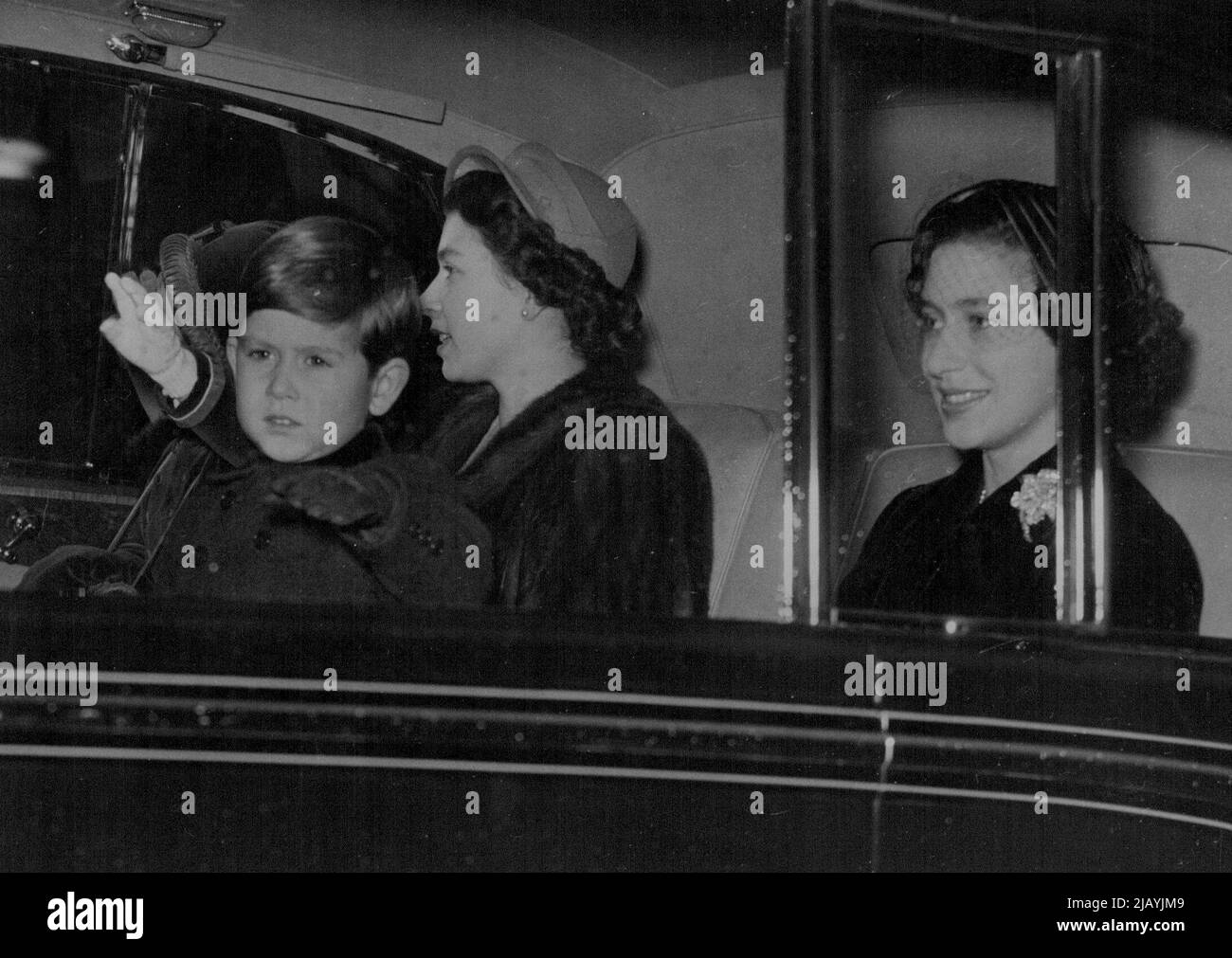 Royal Family Leave For Sandringham : The Queen and her children, Prince Charles and Princess Anne, accompanied by Princess Margaret (right) arriving by car at King's Cross station to-day when they left to spend Christmas at Sandringham. Queen Mary also left for Sandringham in the Royal train. They will join the Duke of Edinburgh, who is already at Sandringham. December 22, 1952. Stock Photo
