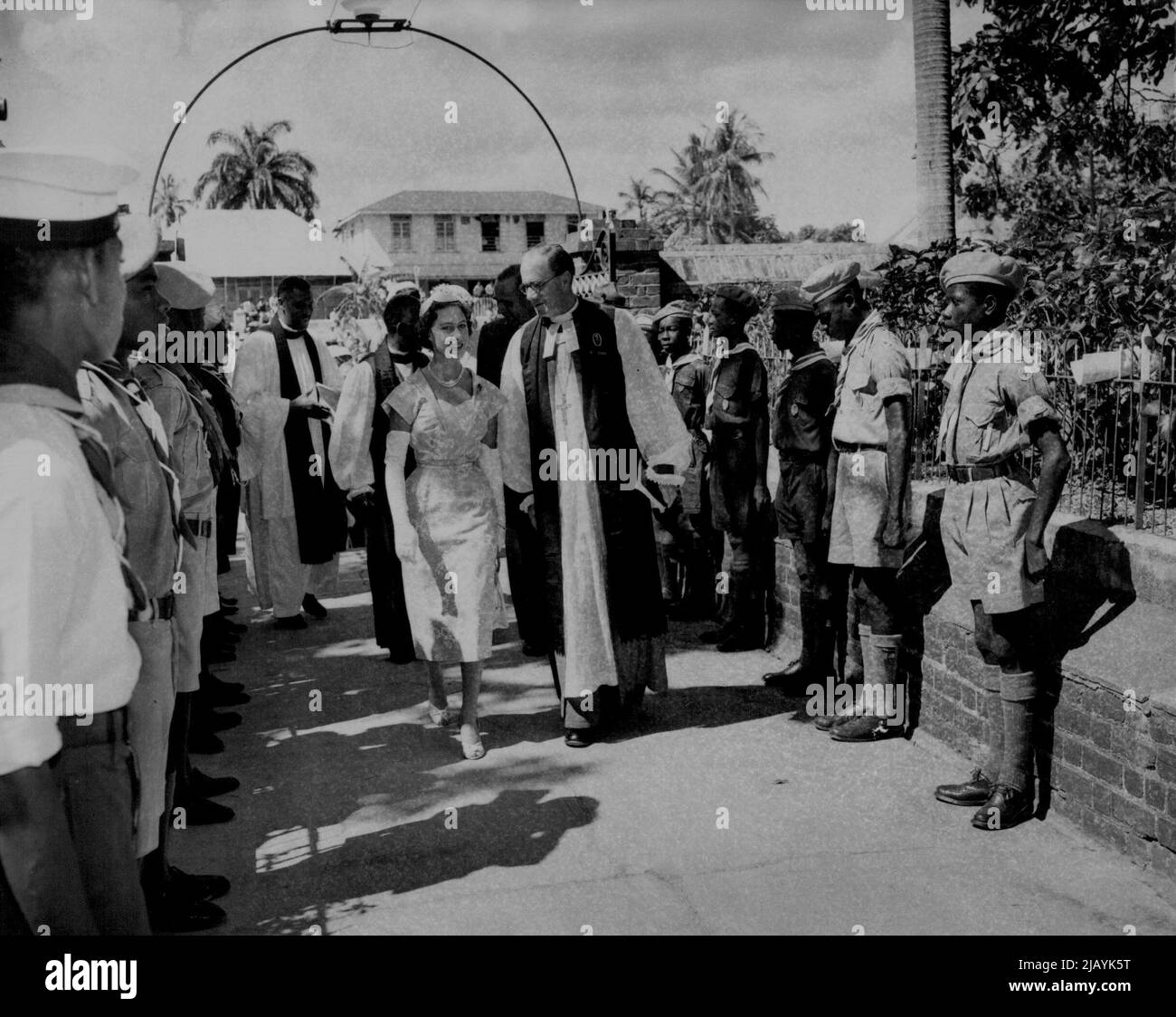 Princess Margaret, accompanied by an unidentified clergyman, arrives at church in Spanish Town, Jamaica, to attend services, Feb. 20. February 21, 1955. (Photo by Associated Press Photo). Stock Photo