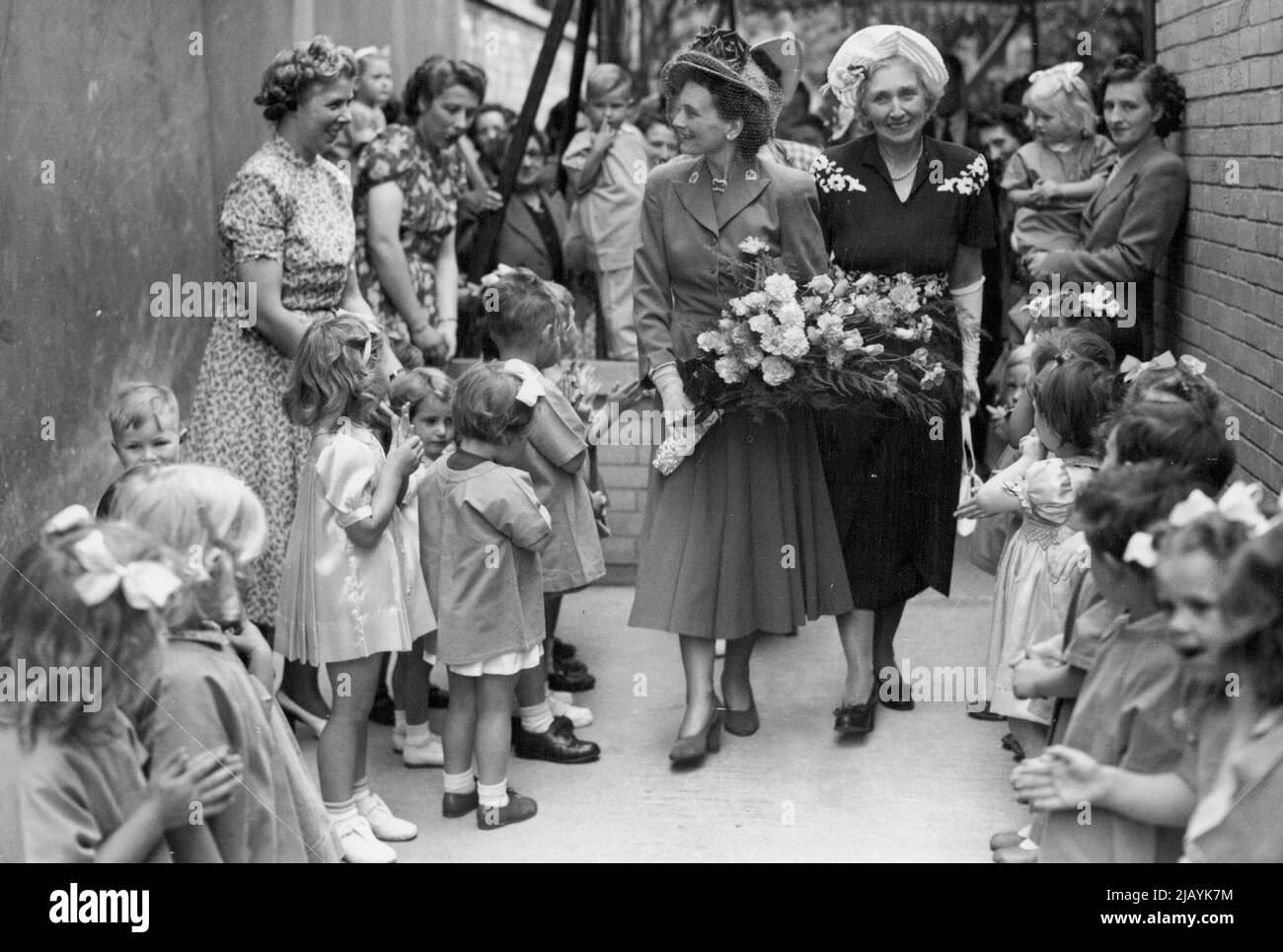 Duchess of Gloucester Opens North London Nursery School -- The Duchess of Gloucester arriving to open the nursery school, with little toddlers waiting to greet her. The Duchess of Gloucester today (Wednesday) opened North Islington Nursery School, Tollington Park, Stroud Green, London., Which is the first of its kind to be built since the war. It stands on the site of one which was destroyed by a bomb in 1940. Already the school has accepted 30 children, and there are 56 more on the waiting list. July 06, 1949. Stock Photo