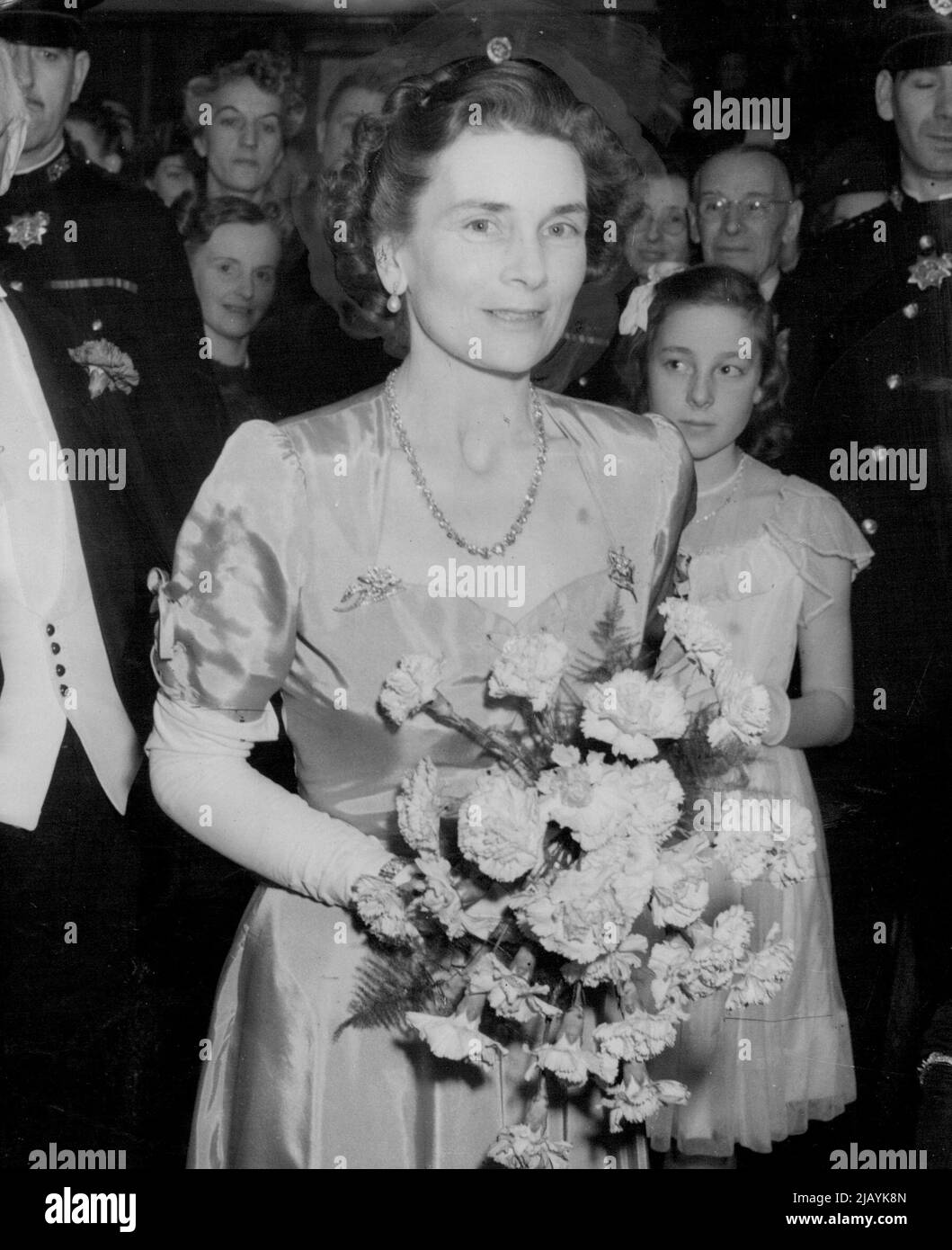 Duchess of Gloucester Attends Film Premiere -- H.R.H. The Duchess of Gloucester, wearing a pink evening gown arriving at the Warner Theatre, London, this evening (Thursday) to attend the film premiere of The Voice of the Turtle' Which features Ronald Reagan and Eleanor Parker. Proceeds are being devoted to the British Empire Cancer Campaign. November 18, 1948. (Photo by Reuterphoto) Stock Photo