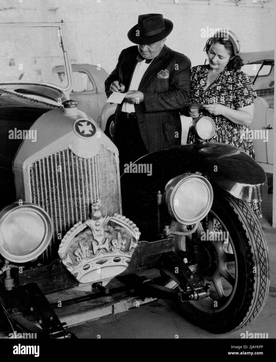 Mr. & Mrs. Sydney Dawson of Manly make an offer for the 1918 Crosley car used by Duke of Windsor during 1920 tour of sale is highest ***** Tenders during XMAS car proceeds in aid of NSW ***** for Crippled children. December 20, 1954. (Photo by Ross/Fairfax Media) Stock Photo