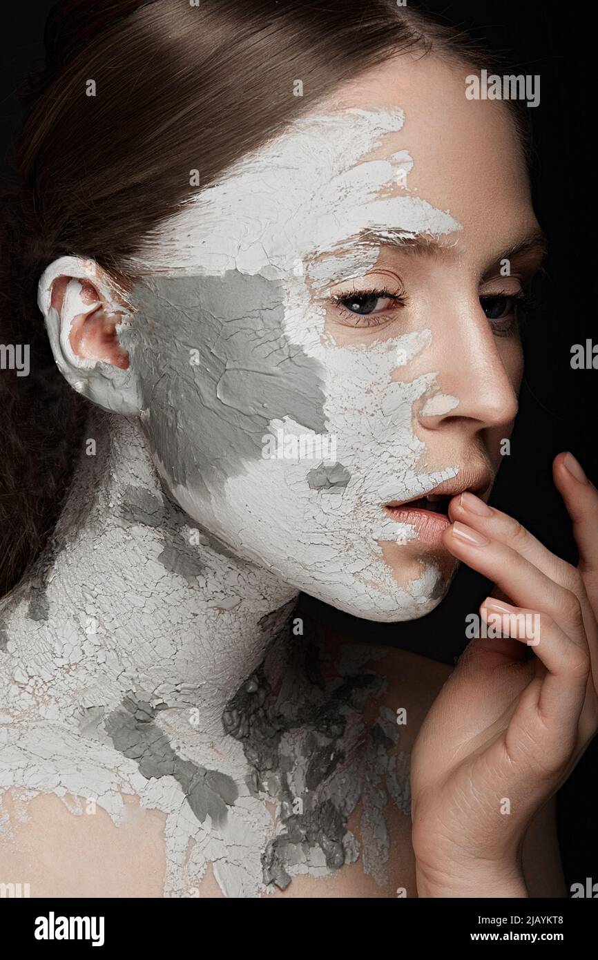 Beautiful girl with mud on his face. Cosmetic mask. Beauty face. Stock Photo