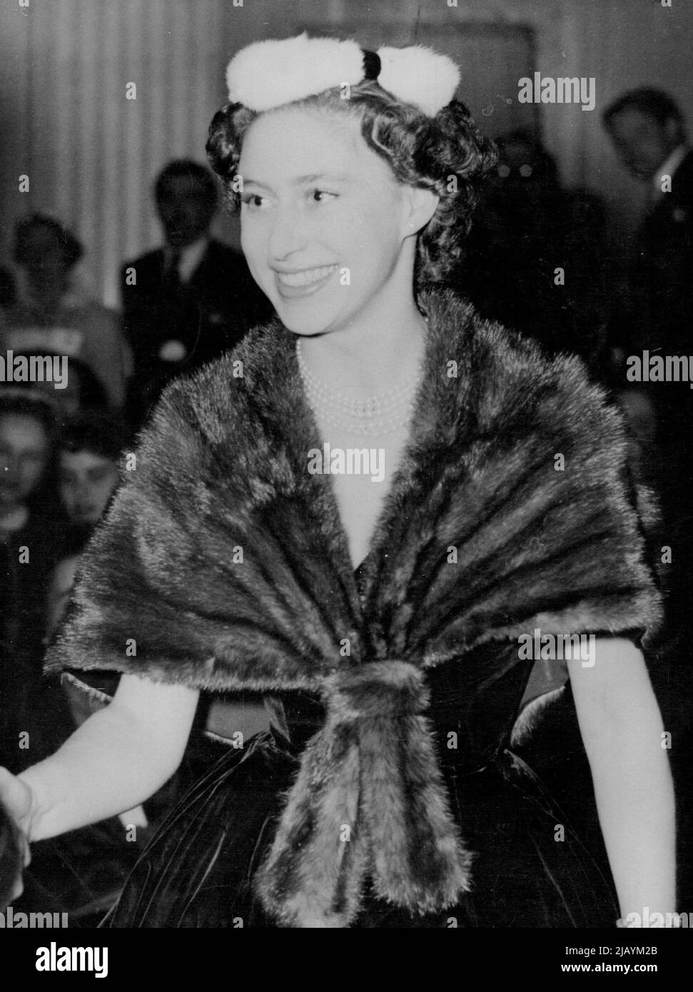 Princess Margaret At Dior Fashion Show in Palace - Princess Margaret is Obviously Enjoying herself at the presentation of Christian Dior's Paris Winter Collection held in Blenheim Palace, ***** Oxfordshire, this evening November 3. Her tiny velvet pill box hat is encircled with white ermine and her mink cape stole is worn over a black velvet dress with a bouffant skirt. About 1,600 guests paid five guineas each to attend the show, staged by 13 mannequins flown from Paris for the occasion. The palace was lent by the Duke and Duchess of Marlborough. November 03, 1954. (Photo by Associated Press Stock Photo