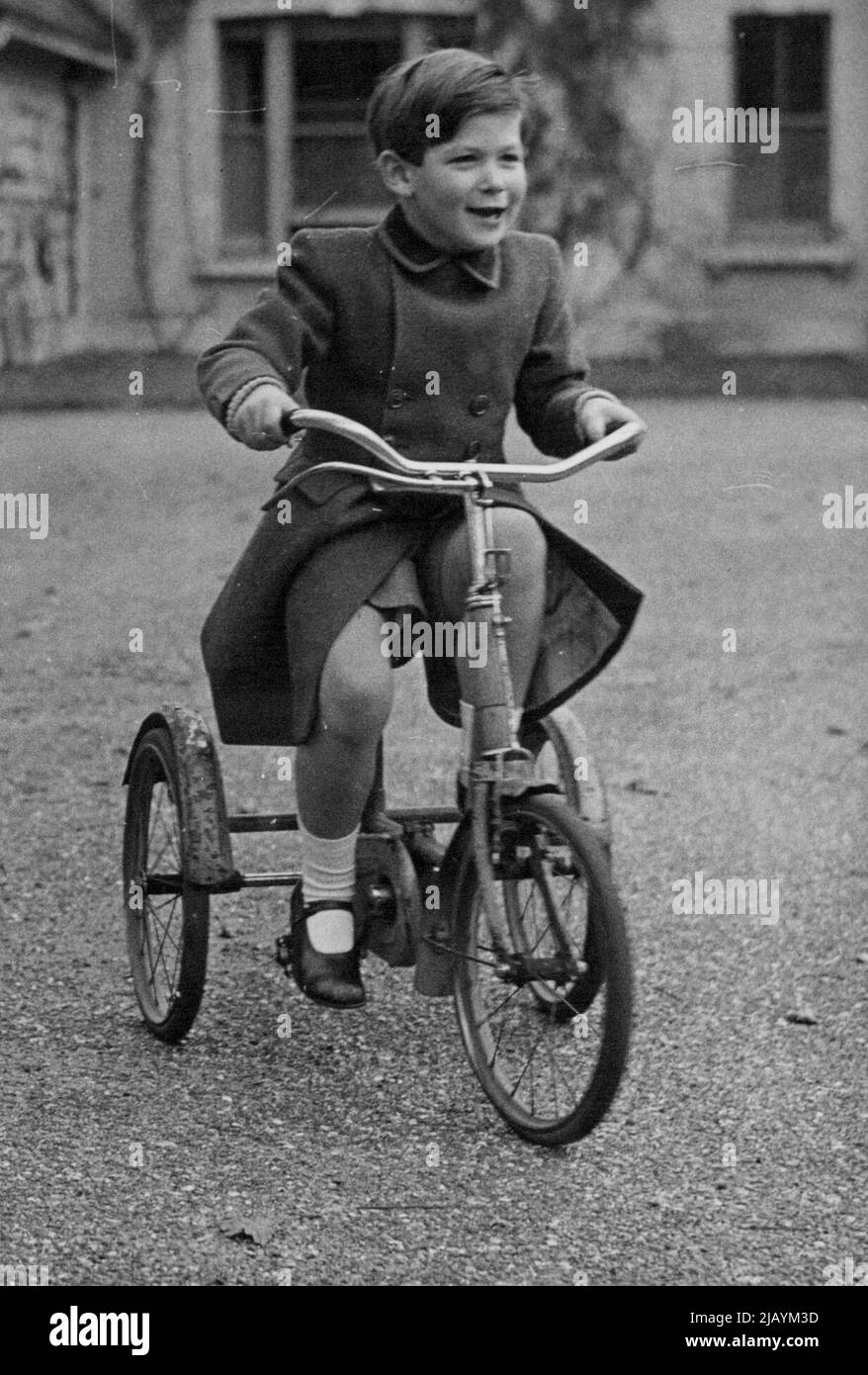Royal Pages - Prince Michael of Kent, with the superb disregard of five years for the heavy responsibilities ahead of him, ***** enjoys himself on his tricycle at his home at Iver, Bucks. Prince Michael of Kent will be one of the pages attending his cousin, Princess Elizabeth at her wedding on the 20th November. 2.11.47. November 18, 1947. Stock Photo