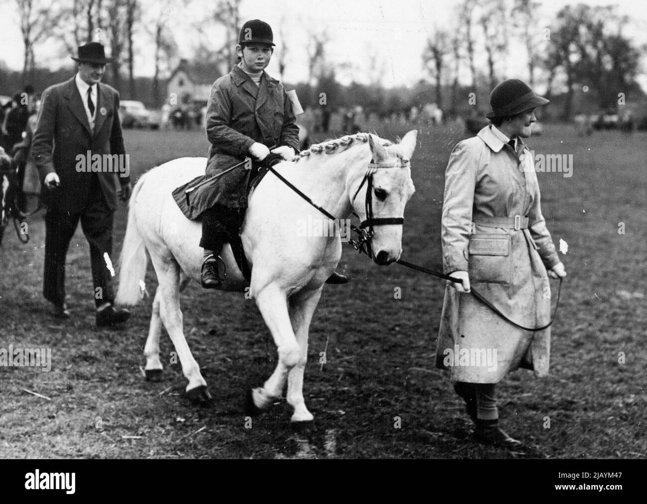 Royal Jumper At Iver Village Horseshow -- Prince Michael of Kent on his white pony 'Pearl', pictured as he is led up to the start of the Class II event at Iver Village Children's Horseshow and Gymkhana (Huntsmoor Park, Monday). He won a second prize. April 11, 1950. (Photo by Fox Photos). Stock Photo