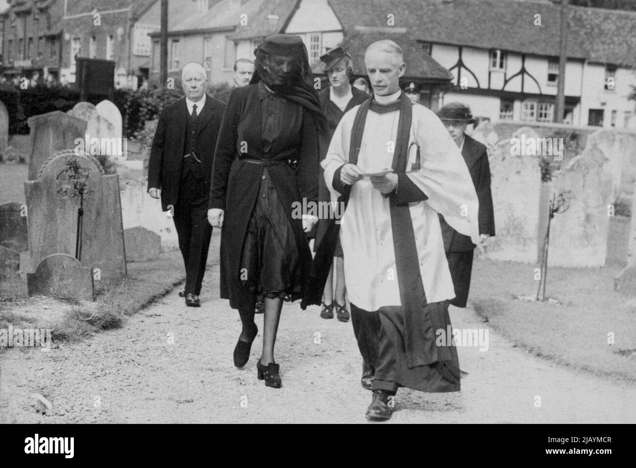 The Duchess of Kent arriving in the little village church in Iver, Bucks, near which she and the late Duke had their country home, to attend a memorial service to her husband. She is with the Vicar, the Rev. Digby Creighton. August 31, 1942. Stock Photo