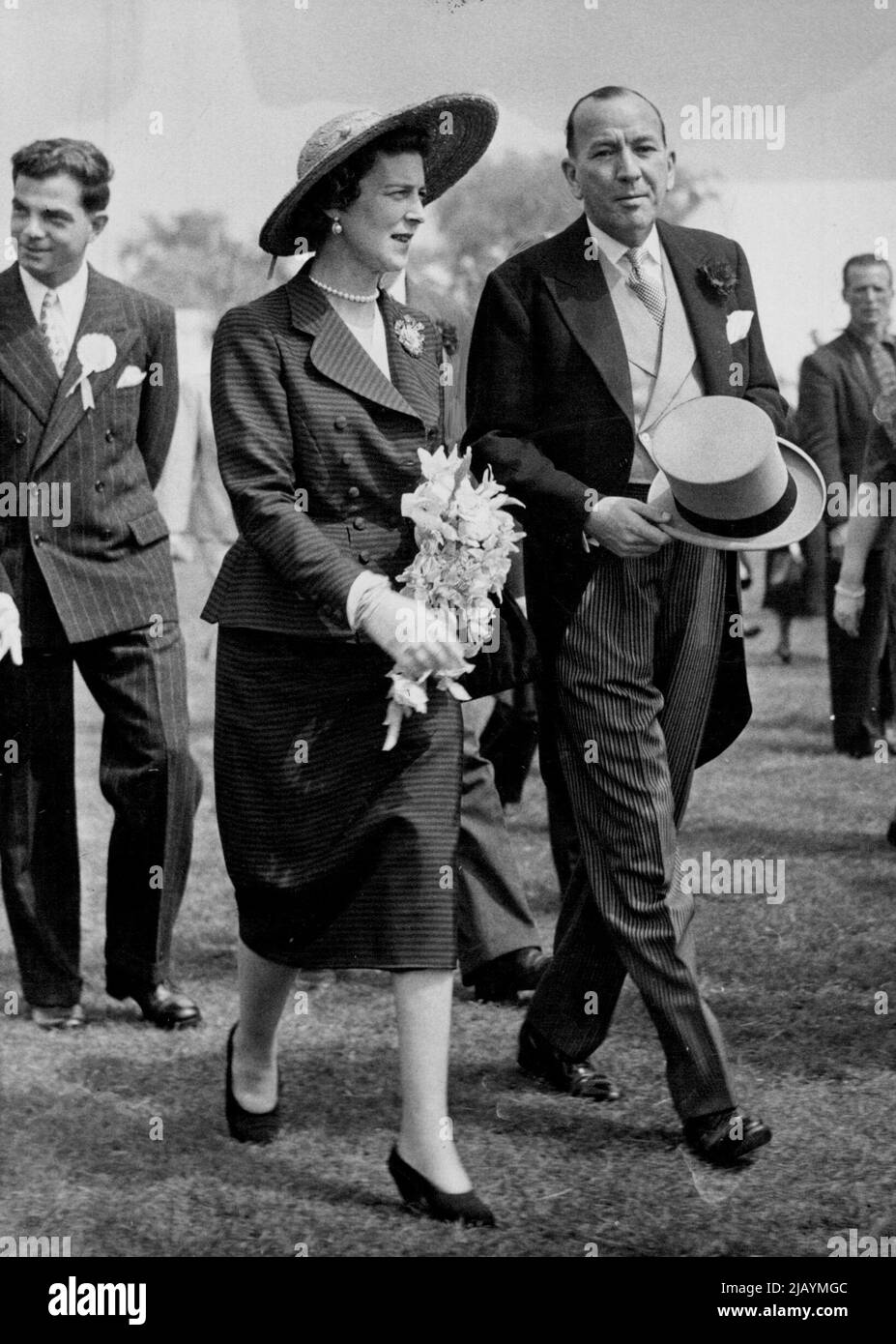 Duchess of Kent Meets Mr. Crowd at Theatre Carnival - The Duchess of Kent wears a wide brimmed hat of dark straw as she is conducted round the Film and Theatre Carnival at Roehampton, today, by stage writer Noel Coward. June 02, 1950. (Photo by Fox Photos). Stock Photo