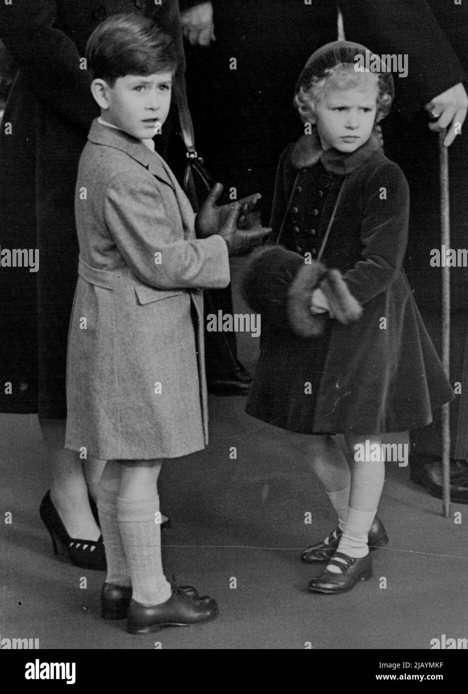 The Queen Mother Arrives Home Again -- The Queen Mother arrived home to-day her tour of America and Canada. The Queen, Duke of Edinburgh, Prince Charles and Princess Anne went to waterloo station to greet her on arrival from Southampton. This picture taken at the station this morning shows the two Royal children awaiting the arrival of their grandmother. November 24, 1954. (Photo by Daily Mail Contract Picture). Stock Photo