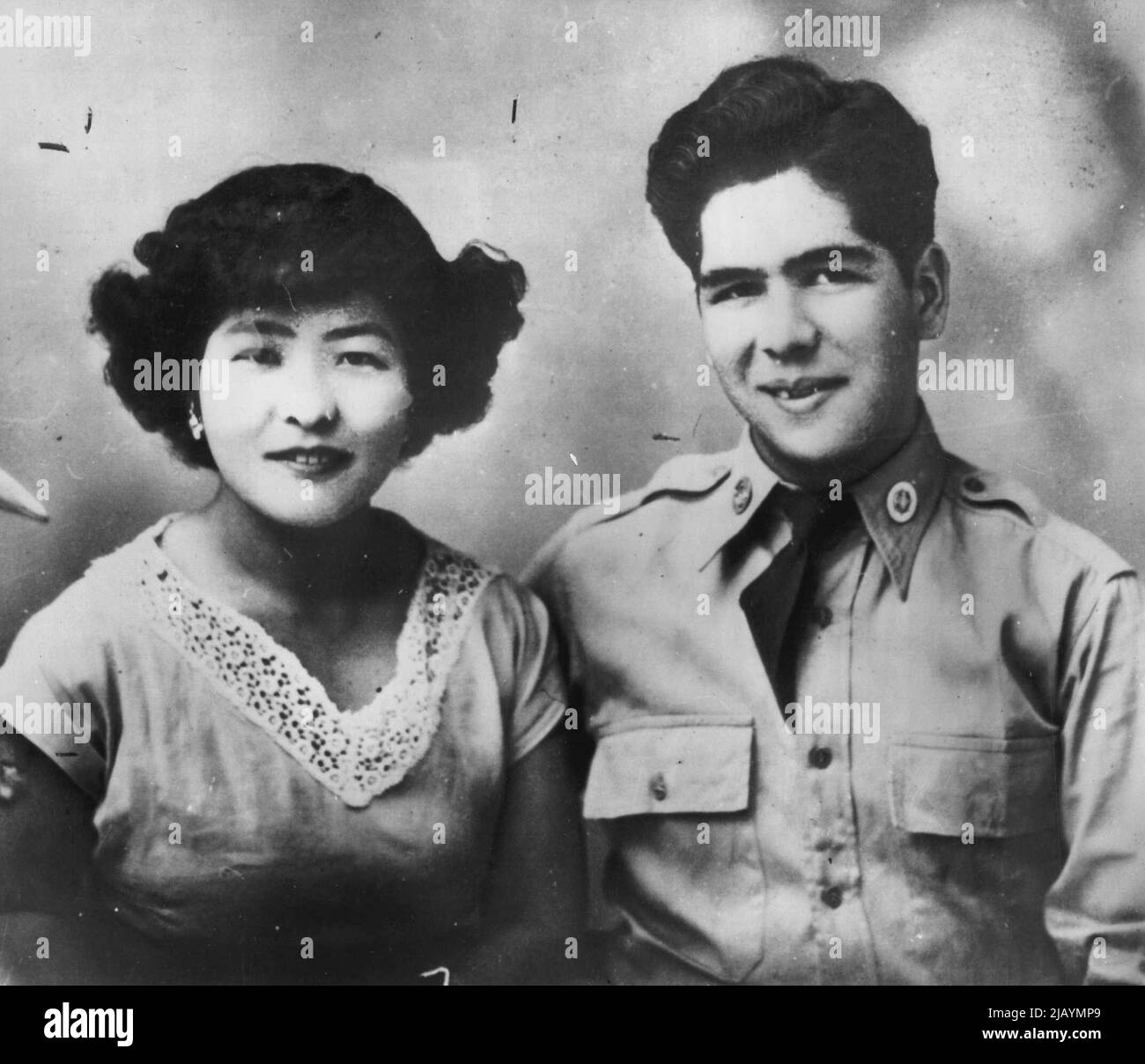 War Bride Is Happy Now -- Nobuko Coronel, an Oriental War bride, is en route from Okinawa to her new home here with her husband, Cpl. Robert A. Coronel with whom she's pictured, and her baby, light-hearted in the knowledge that she's wanted. The Alhambra Post-Advocate published a letter from Coronel expressing her fears that she would not be accepted. It received 70 letters from readers -- which the newspaper forwarded to Nobuko--assuring her that she would be Welcome. April 25, 1952. (Photo by AP Wirephoto). Stock Photo
