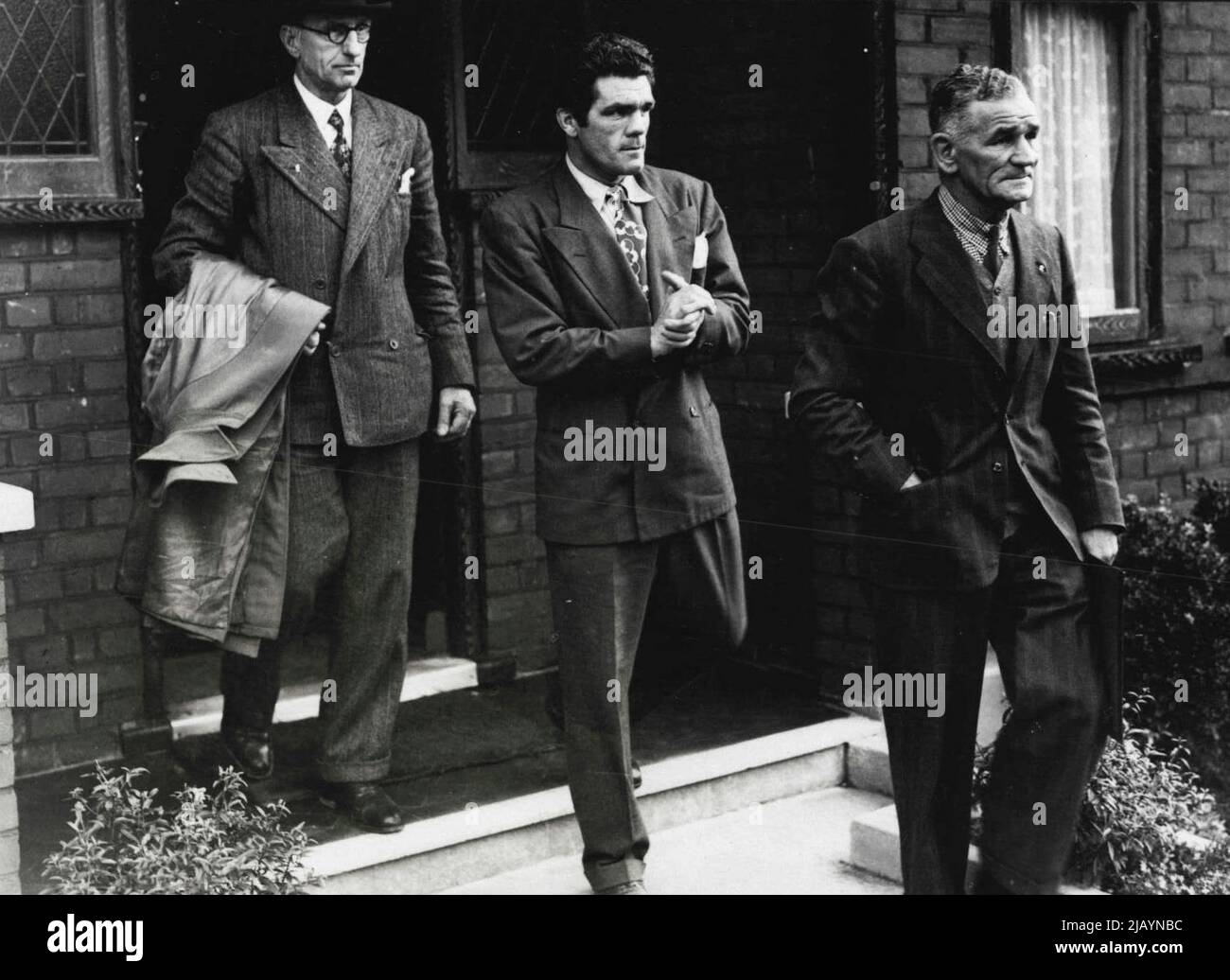 Champion Sees Specialist -- Freddie Mills (centre) ***** manager Ted Broadribb (right), carrying the champion's X-Ray films - and an official of the British Boxing Board of Control, leaving to see a London special list this evening. Freddie Mills 28-year-old world light heavyweight boxing champion was told to-night the ***** will be able to box again. so he ***** not, as feared, have to give up ***** ring through spinal injuries. August 20, 1948. Stock Photo