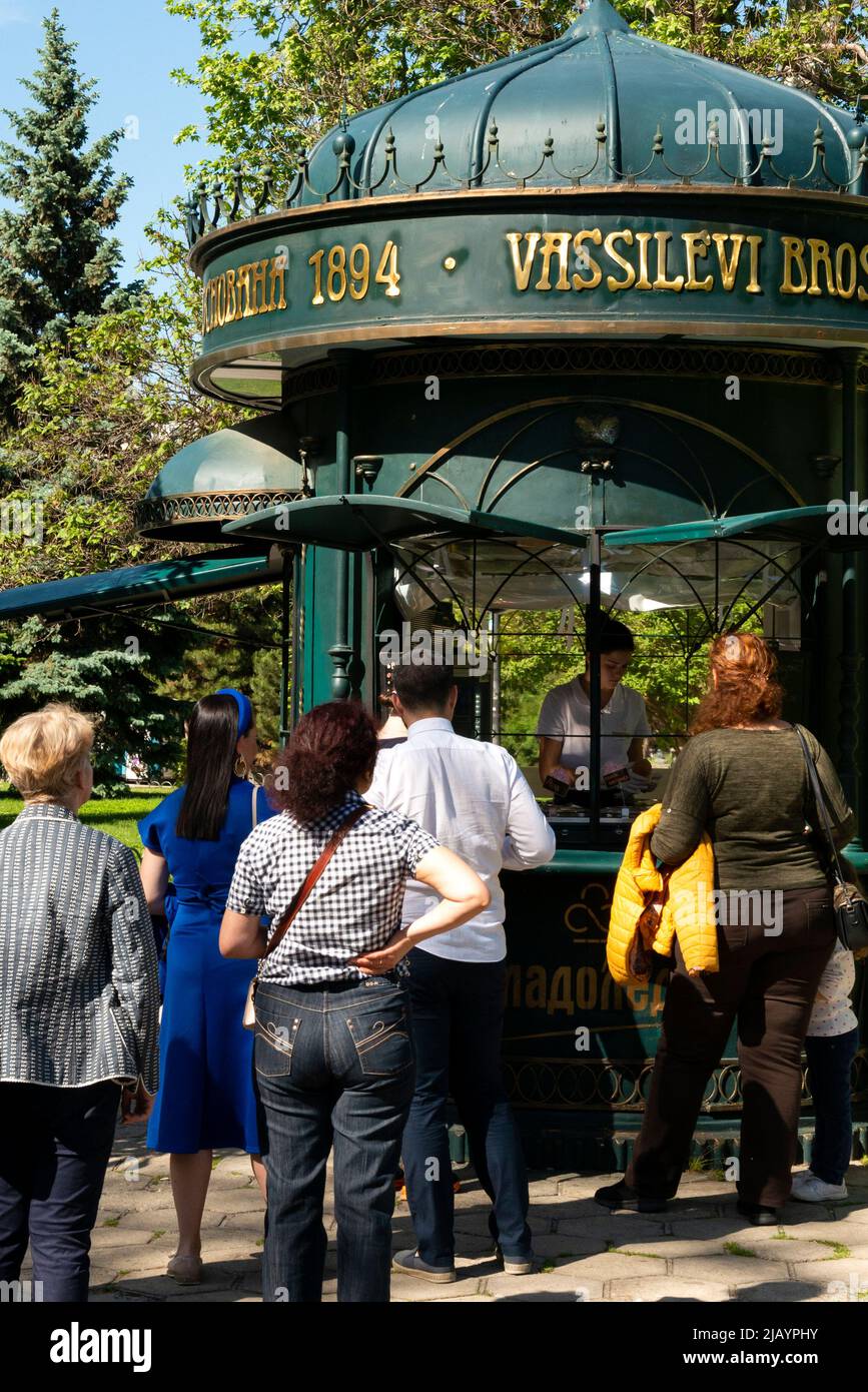 People queueing for ice cream at a vintage stall in the City Garden downtown Sofia, Bulgaria, Eastern Europe, Balkans Stock Photo