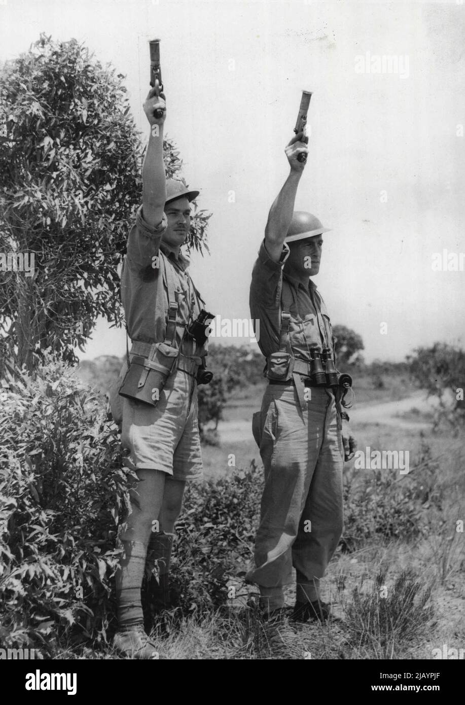 Attack Signal -- Troops tensed for an assault on 'enemy' positions on Army manoeuvres receiving a signal to open operations. July 11, 1950. Stock Photo