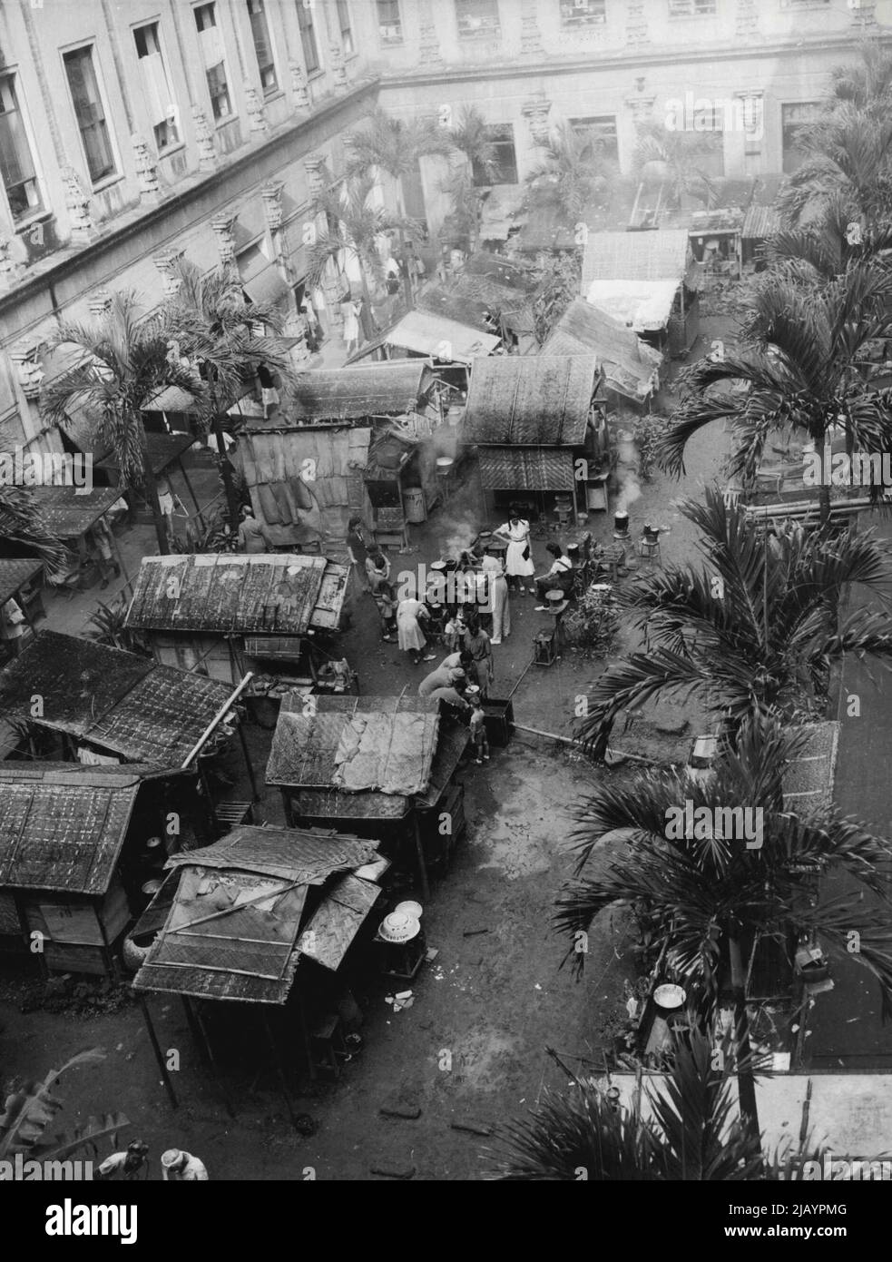 Home For Some 400 Internees -- These rudely constructed shanties at the rear of the Santa Tomas internment camp in Manila, P.I., were the homes of some 400 of the 3,700 internees who were freed by American troops Feb. 5 (Manila Time). The entry of the yanks ended three years imprisonment for the internees. February 13, 1945. (Photo by Associated Press Photo). Stock Photo
