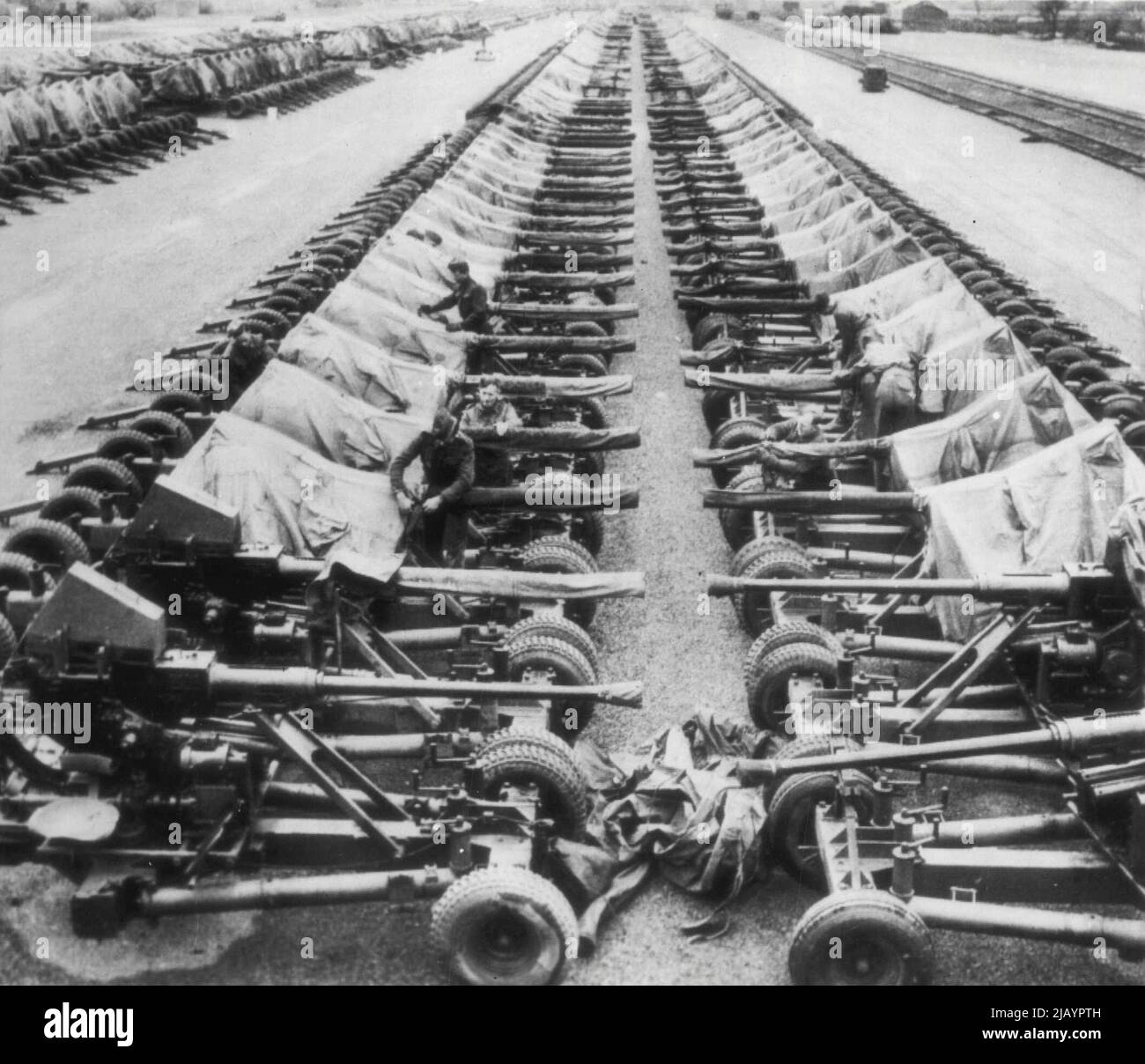 They'll Protect Allies From Luftwaffe -- Long lines of 40mm. Bofors light anti-aircraft guns stand nose to nose on a field in Britain awaiting the day of invasion of continental Europe. May 10, 1944. (Photo by AP Wirephoto). Stock Photo