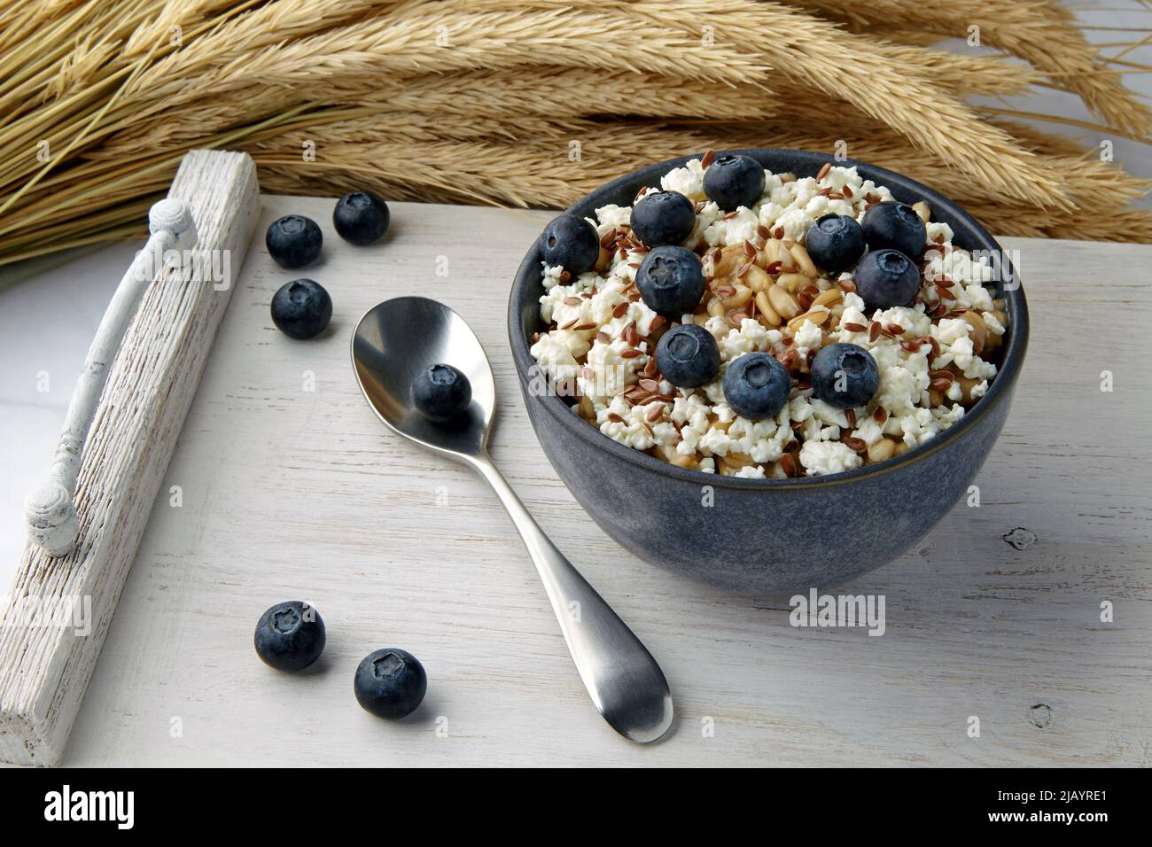 Whole grain oat porridge with blueberries, flax seeds and curd