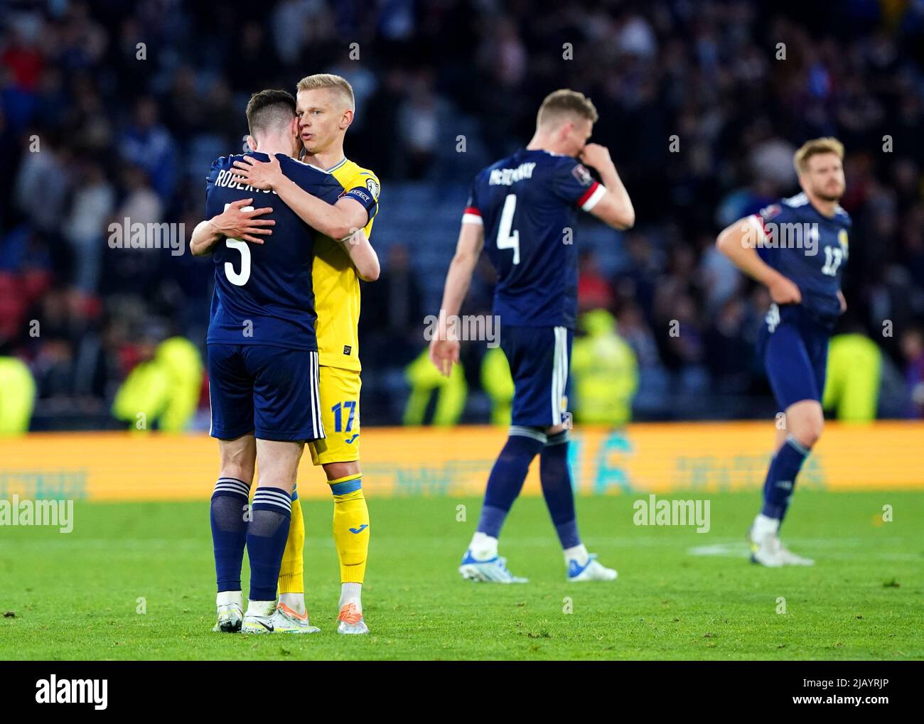 Scotland's Andrew Robertson (left) hugs Ukraine's Oleksandr Zinchenko