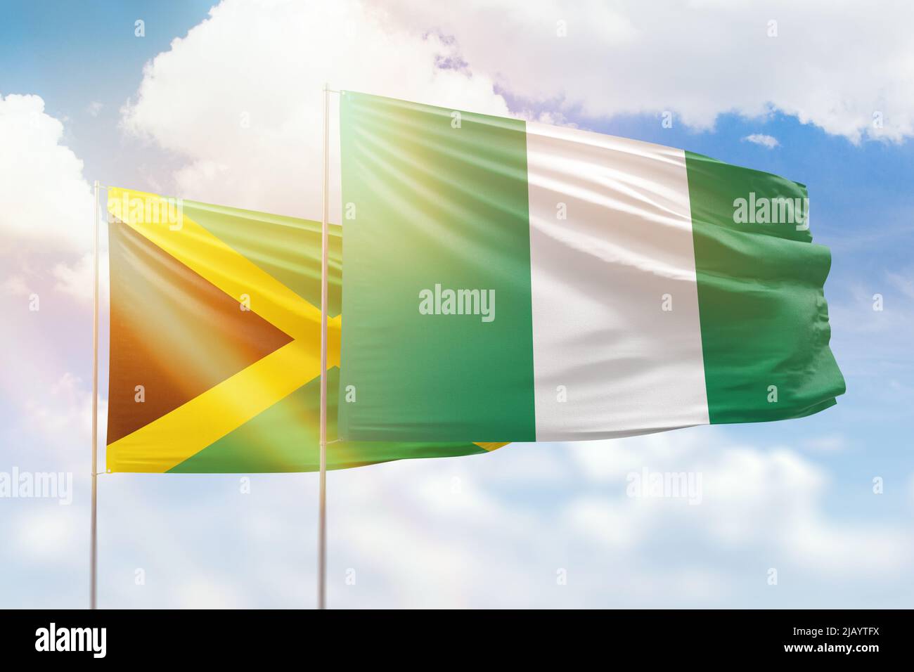 Sunny blue sky and flags of nigeria and jamaica Stock Photo - Alamy