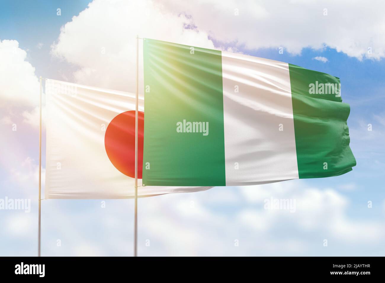Sunny blue sky and flags of nigeria and japan Stock Photo Alamy