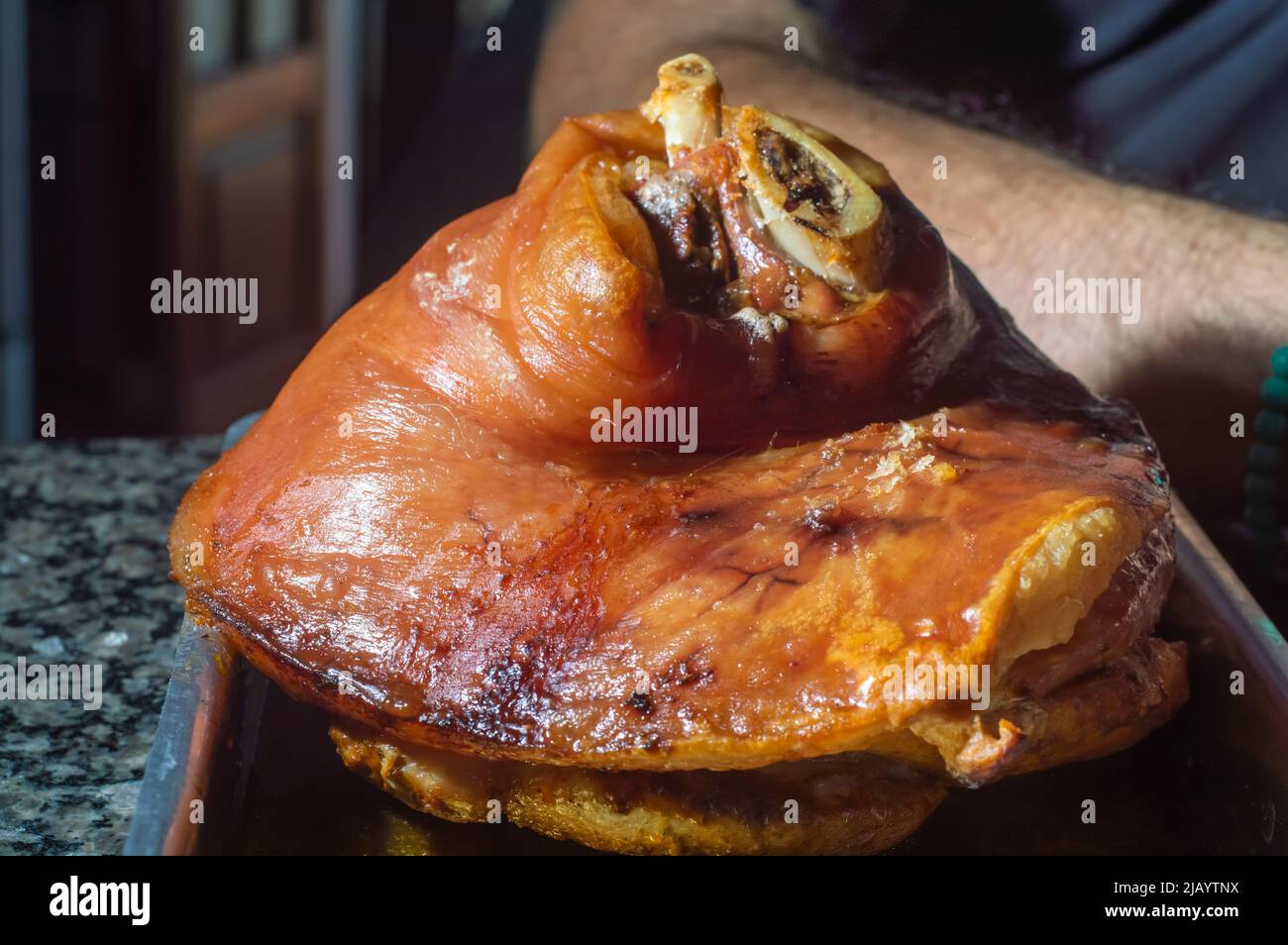 Roasted pork knuckle eisbein with cabbage and mustard on wooden cutting board. Stock Photo