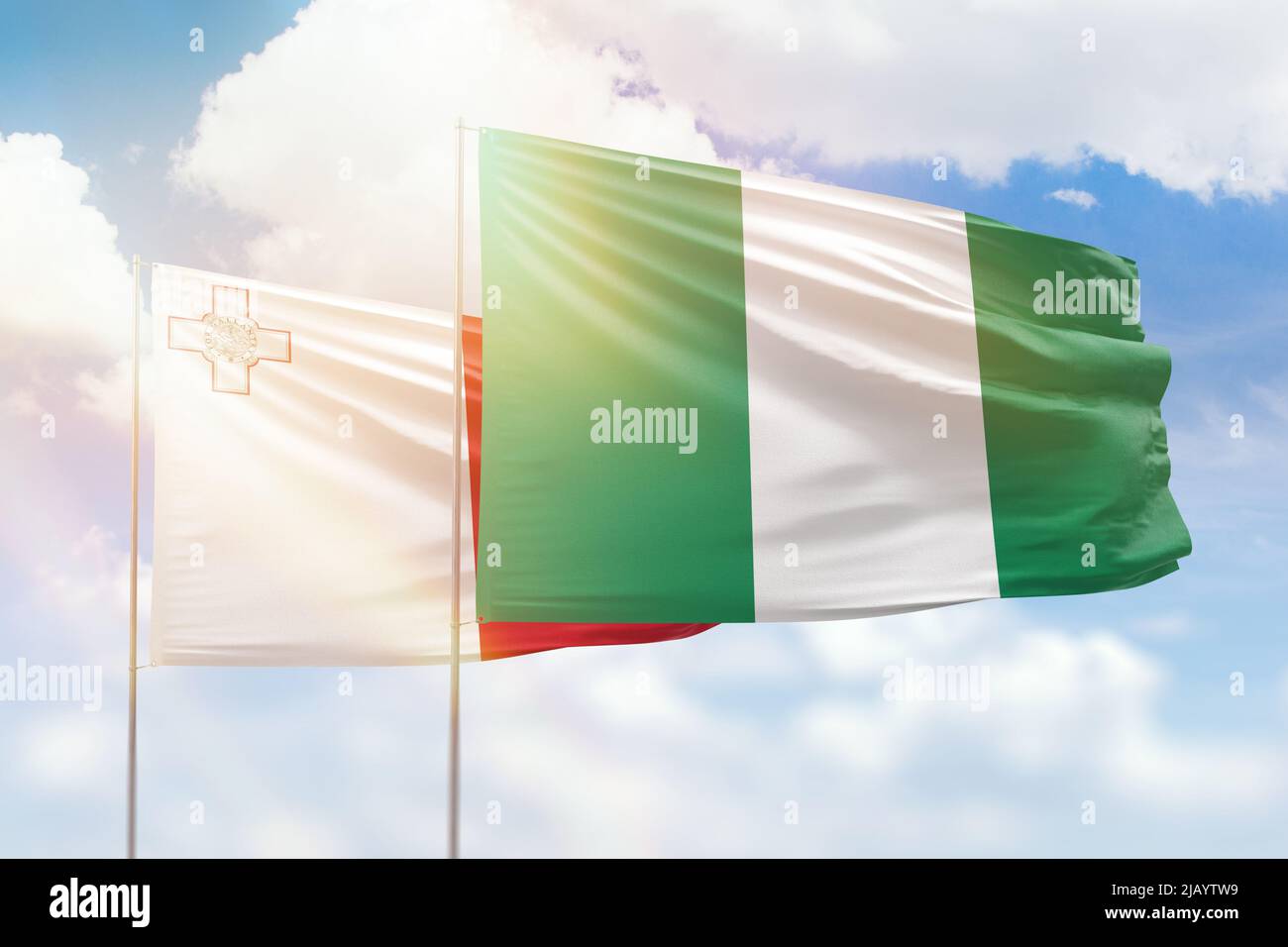 Sunny blue sky and flags of nigeria and malta Stock Photo Alamy