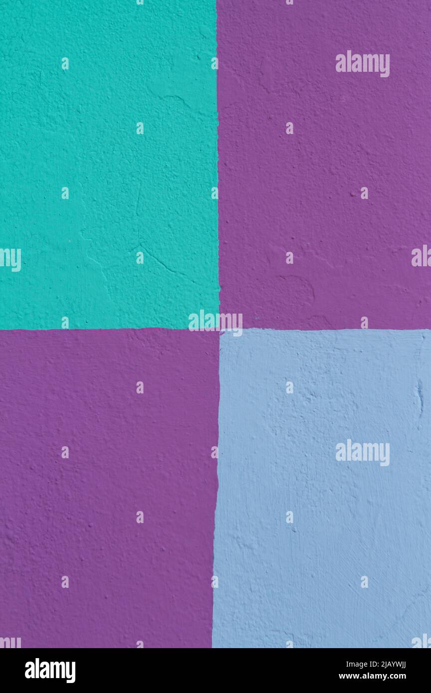 Colorful geometric shapes in shades of blue and purple on a painted