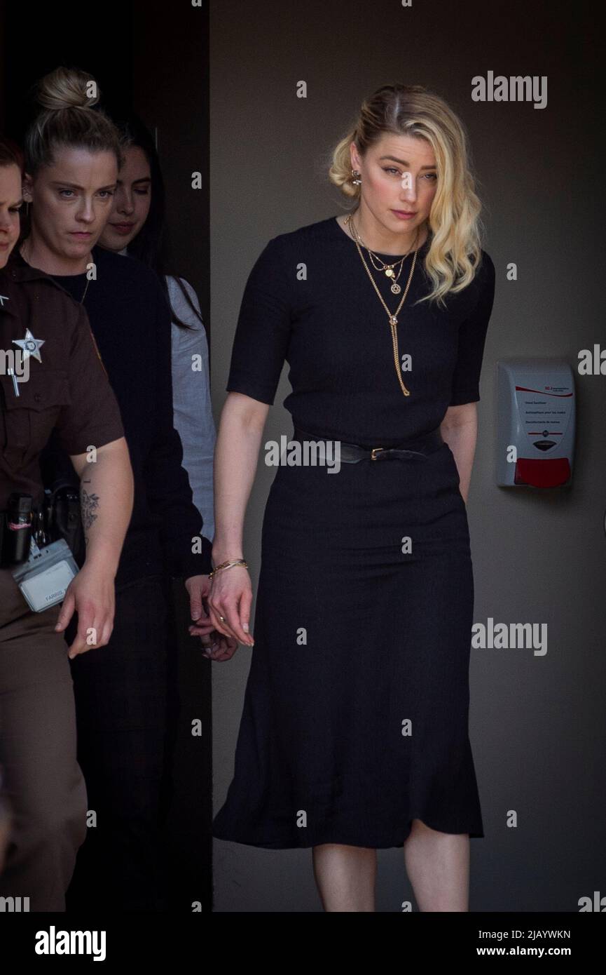 Actress Amber Heard, right, and her sister Whitney Heard, left, depart