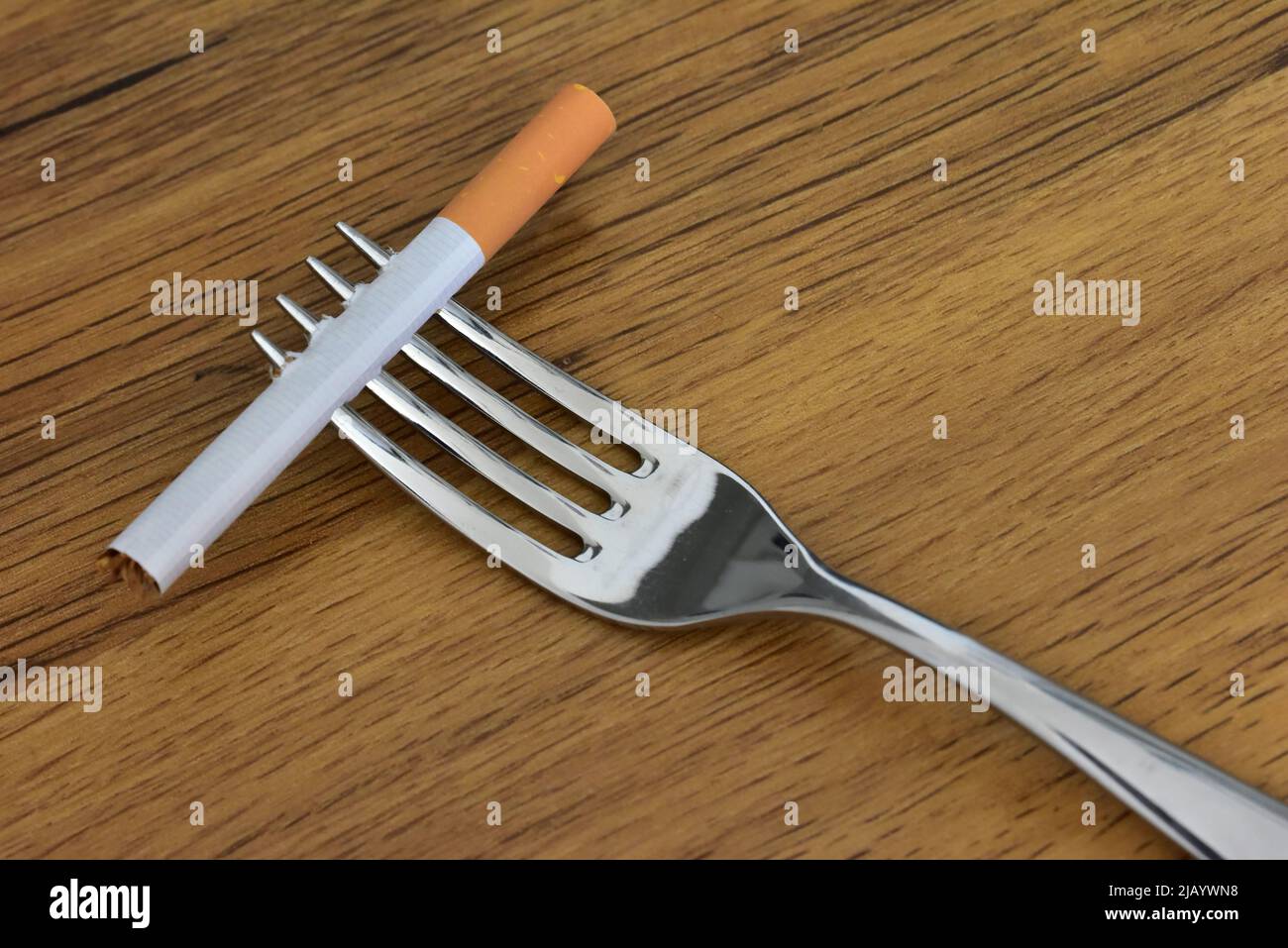 dinner fork with cigarette Stock Photo
