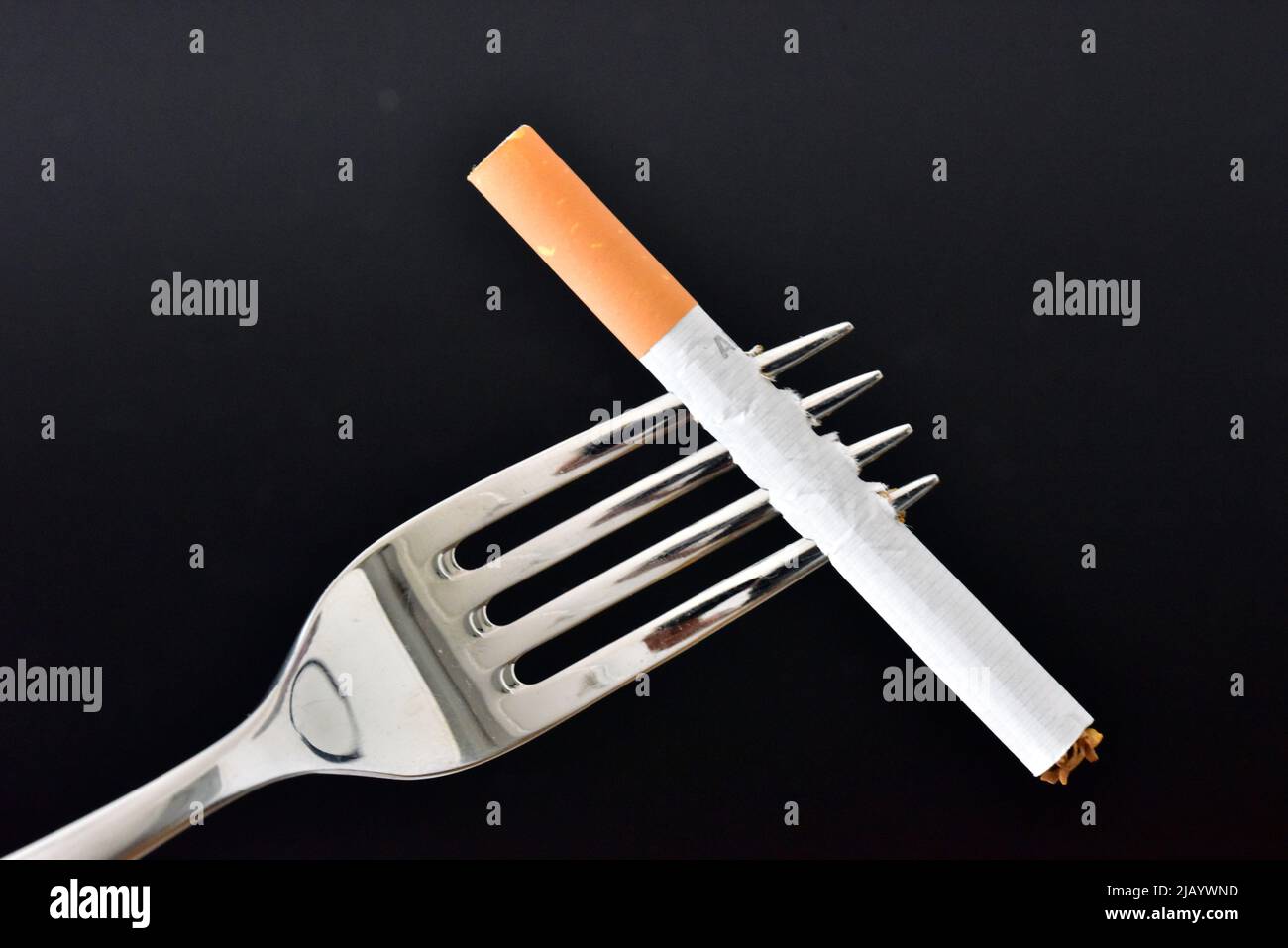 dinner fork with cigarette Stock Photo