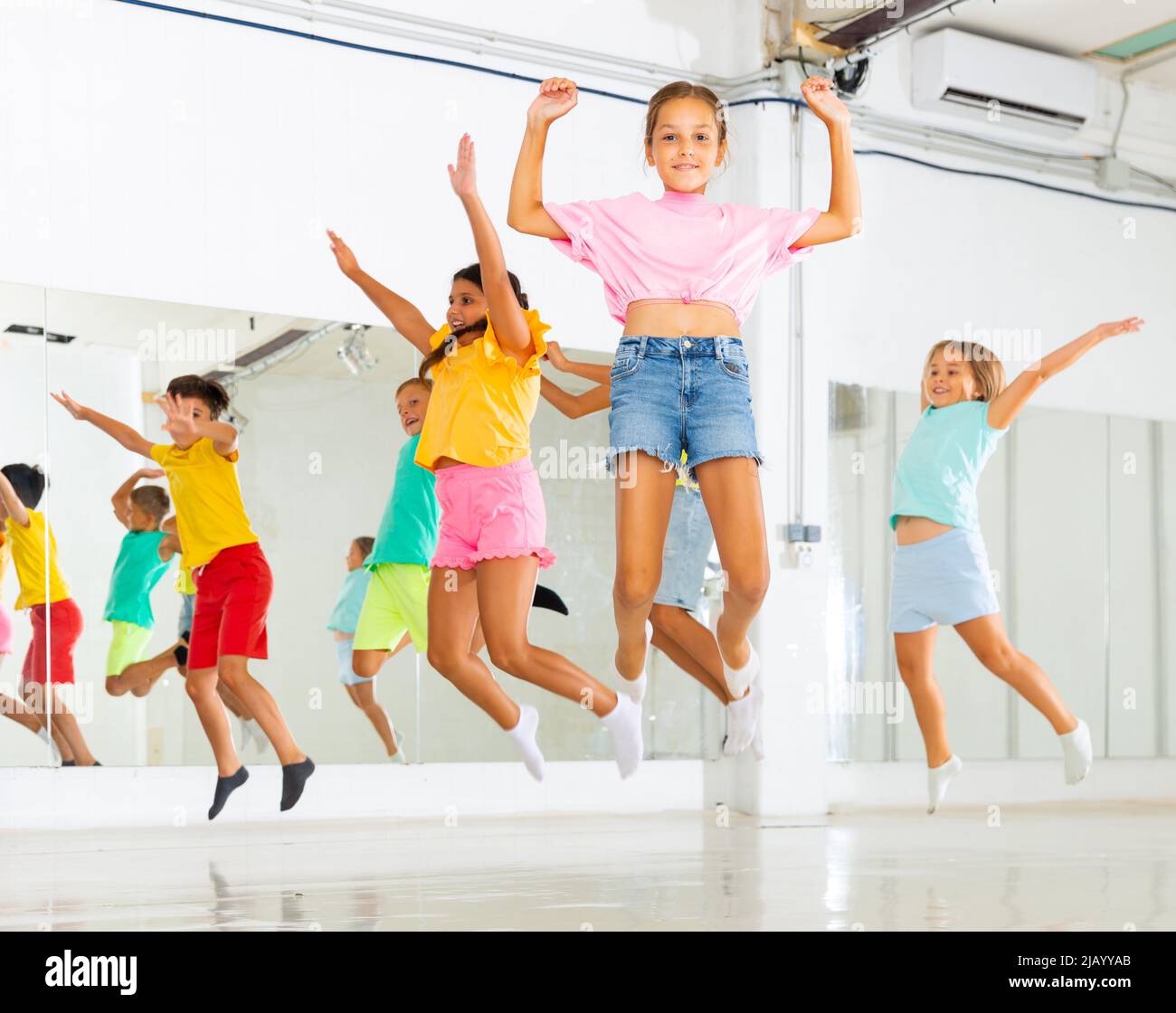 Kids jumping together in studio Stock Photo - Alamy