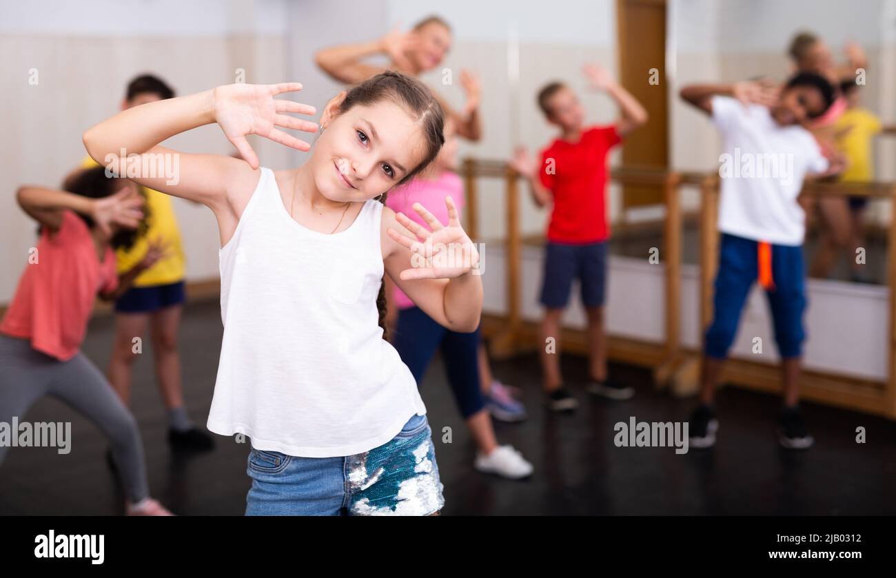 Girl exercising in group during dance class Stock Photo