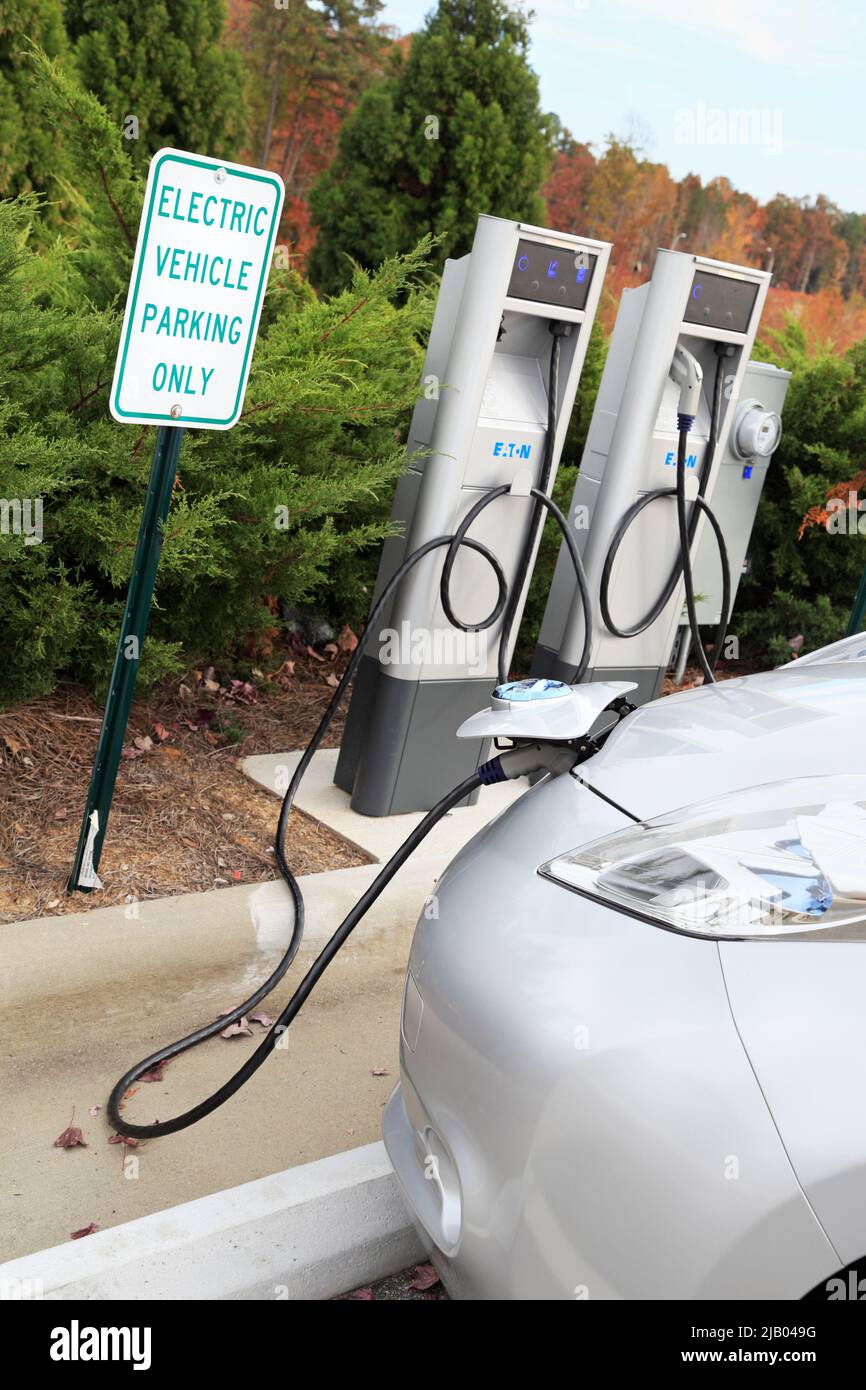 Parking space with an electrical vehicle charging the battery Stock