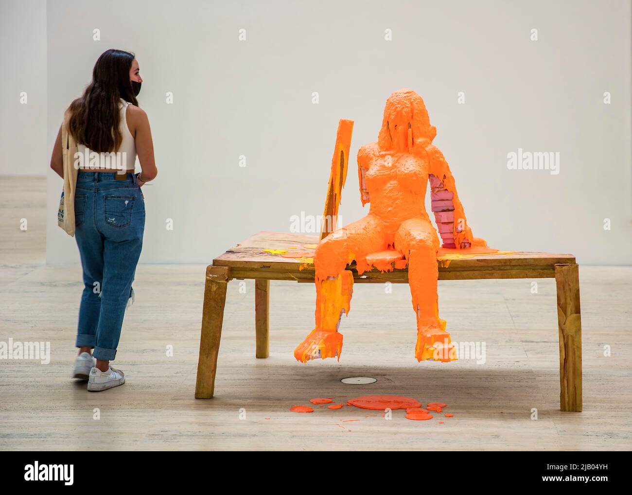 Woman wearing a facemask during the Covid-19 pandemic looks at artwork by Swiss conceptual artist Urs Fischer in the Jumex Museum Stock Photo