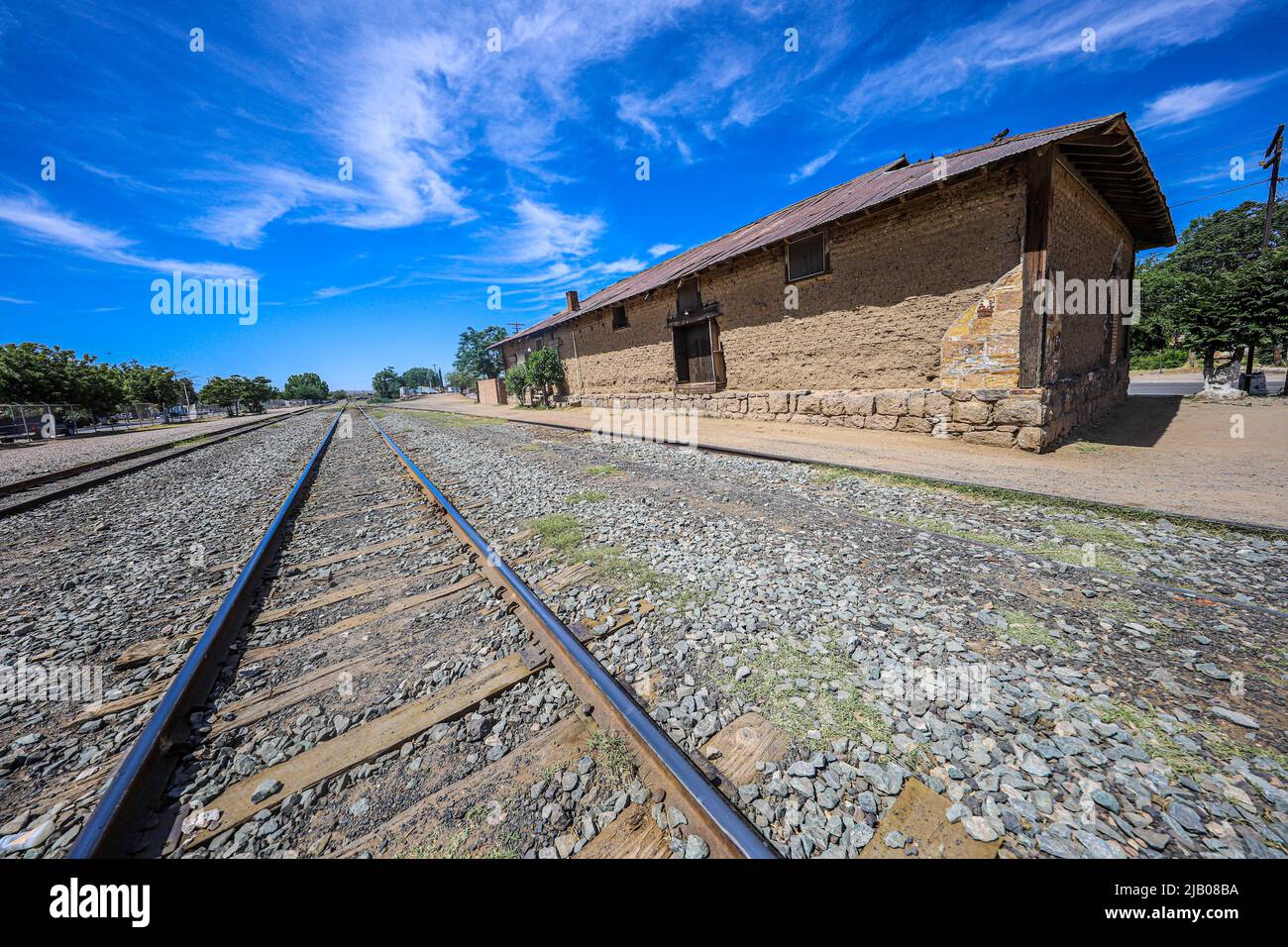 Train tracks, railway and old adobe train station in Esqueda, Mexico ...
