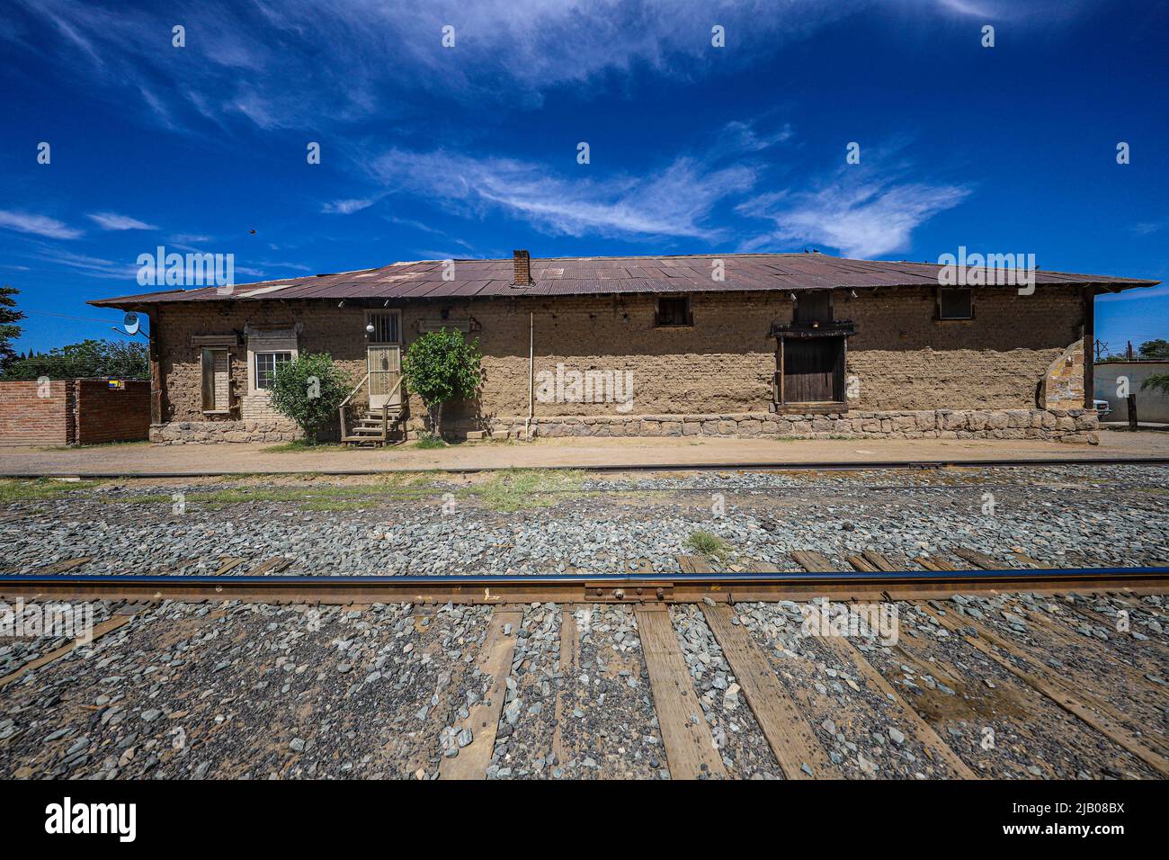 Train tracks, railway and old adobe train station in Esqueda, Mexico ...