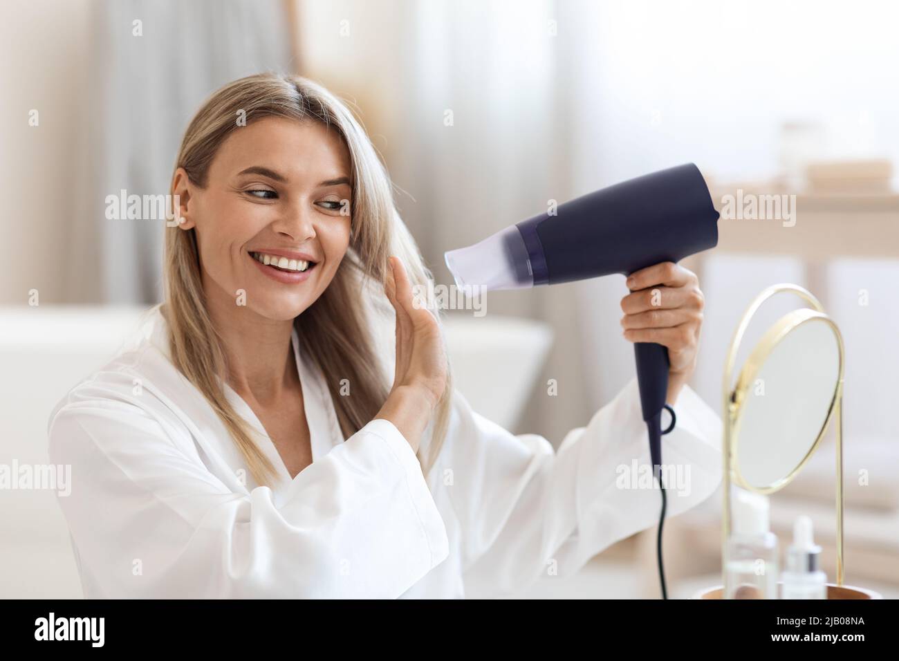 Care hair using dryer hi-res stock photography and images - Alamy
