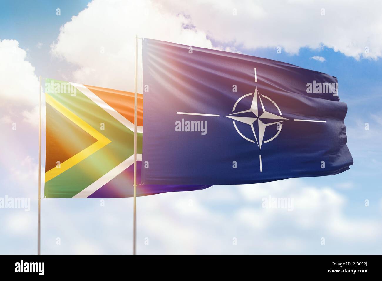 Sunny blue sky and flags of nato and south africa Stock Photo Alamy