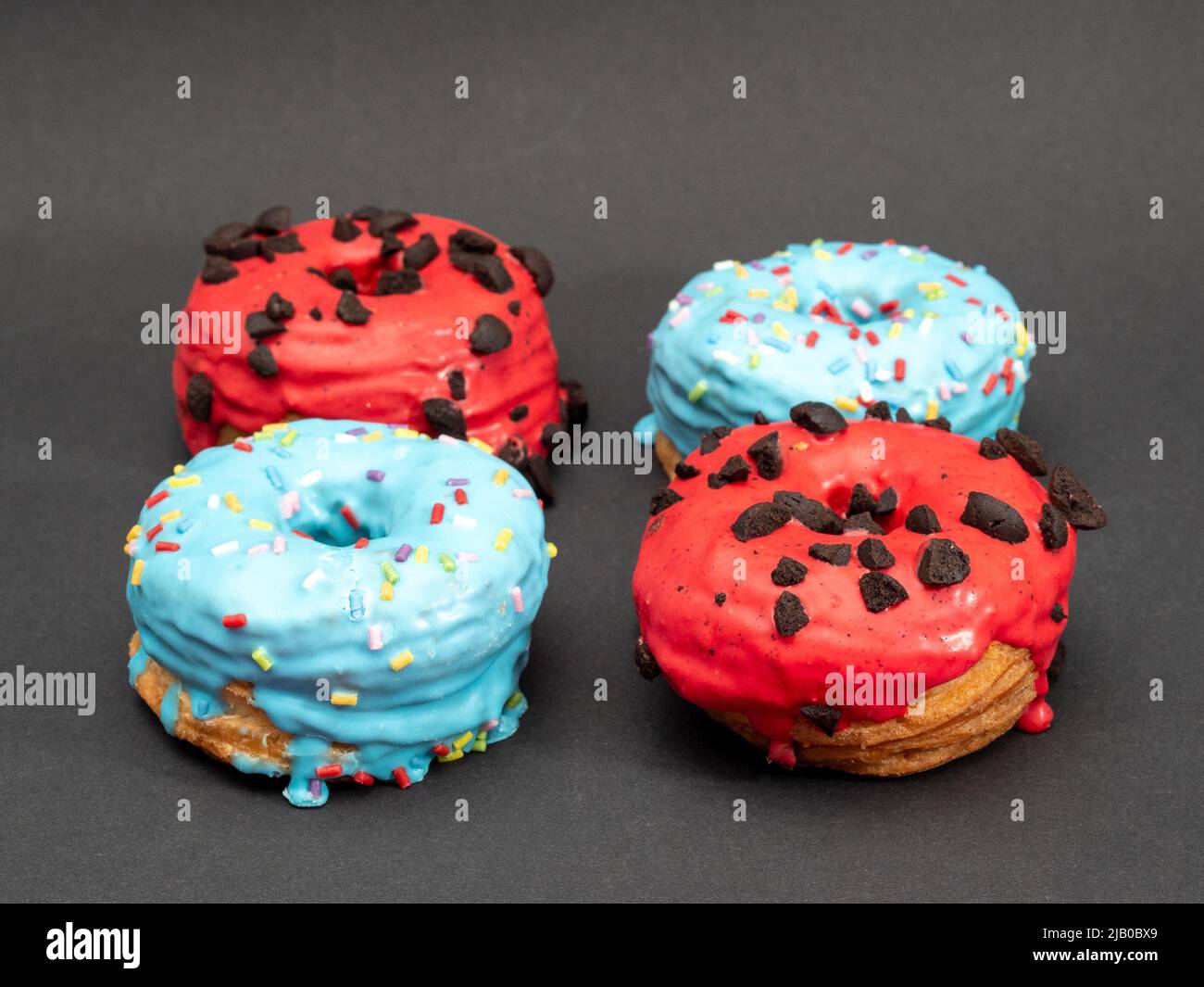 Red and blue cronuts on a black background. High quality photo Stock ...